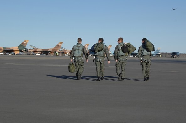 EIELSON AIR FORCE BASE, Alaska -- Four F-16 Fighting Falcon pilots from the 64th Aggressor Squadron, Nellis Air Force Base, Nevada step to their jets prior to a mission during Red Flag-Alaska 07-1. Red Flag-Alaska is a Pacific Air Forces-directed field training exercise for U.S. forces flown under simulated air combat conditions. It is conducted on the Pacific Alaskan Range Complex with air operations flown out of Eielson and Elmendorf Air Force Bases. (U.S. Air Force Photo by Staff Sgt Joshua Strang)