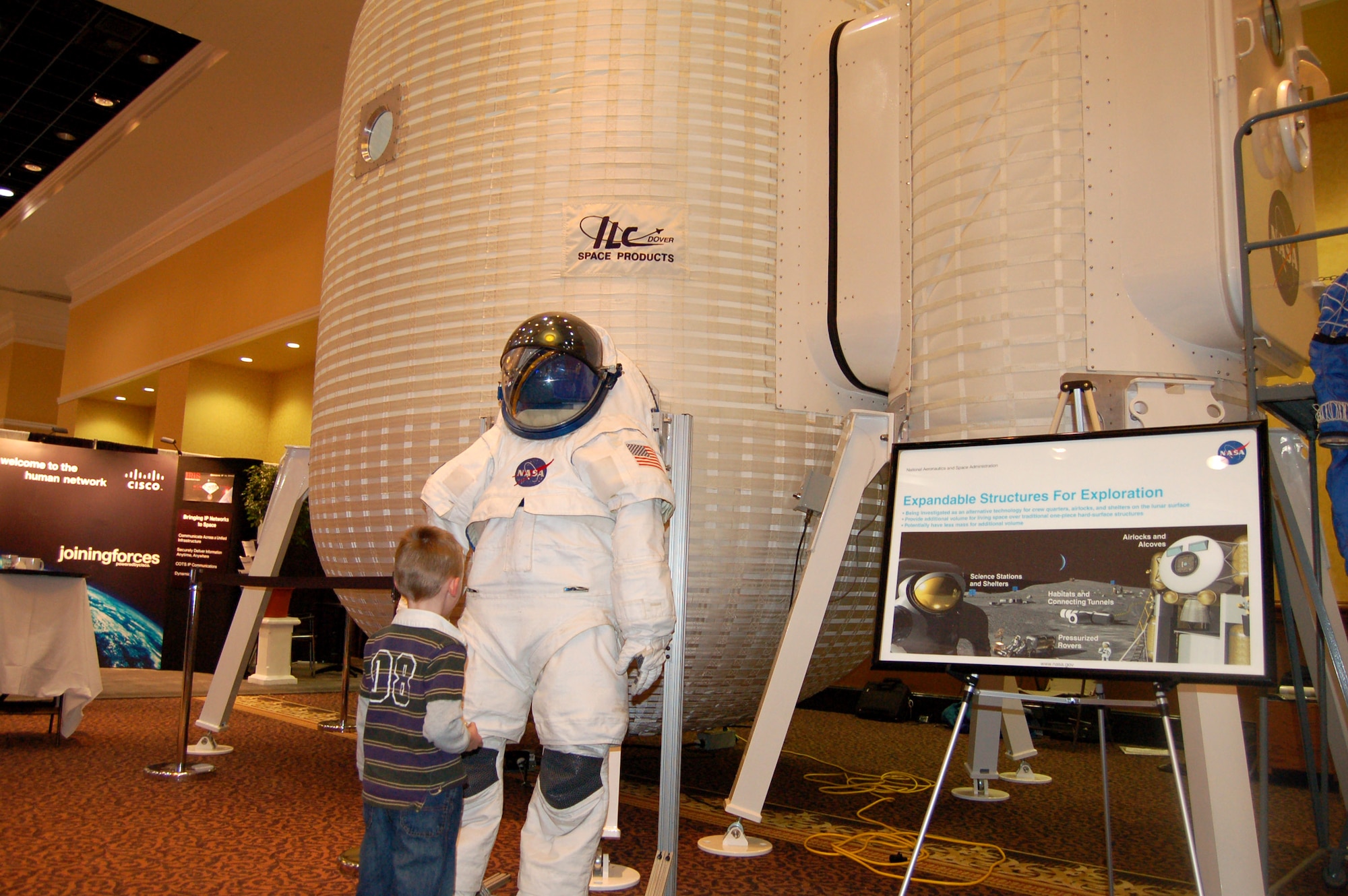 Reid Sherman looks up at a display during the 23rd National Space Symposium April 12 at the Broadmoor in Colorado Springs, Colo. In addition to the exhibits, there were numerous guest speakers at the event. (U.S. Air Force photo/Staff Sgt. Jeremy Larlee)