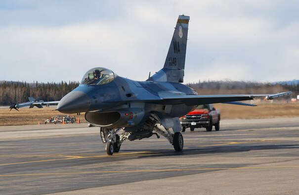 EIELSON AIR FORCE BASE, Alaska -- An F-16 Fighting Falcon from the 64th Aggressor Squadron, Nellis Air Force Base, Nevada taxis for take off during Red Flag-Alaska 07-1 here on April 16. Red Flag-Alaska is a Pacific Air Forces-directed field training exercise for U.S. forces flown under simulated air combat conditions. It is conducted on the Pacific Alaskan Range Complex with air operations flown out of Eielson and Elmendorf Air Force Bases.   (U.S. Air Force Photo by Staff Sgt Tia Schroeder) 