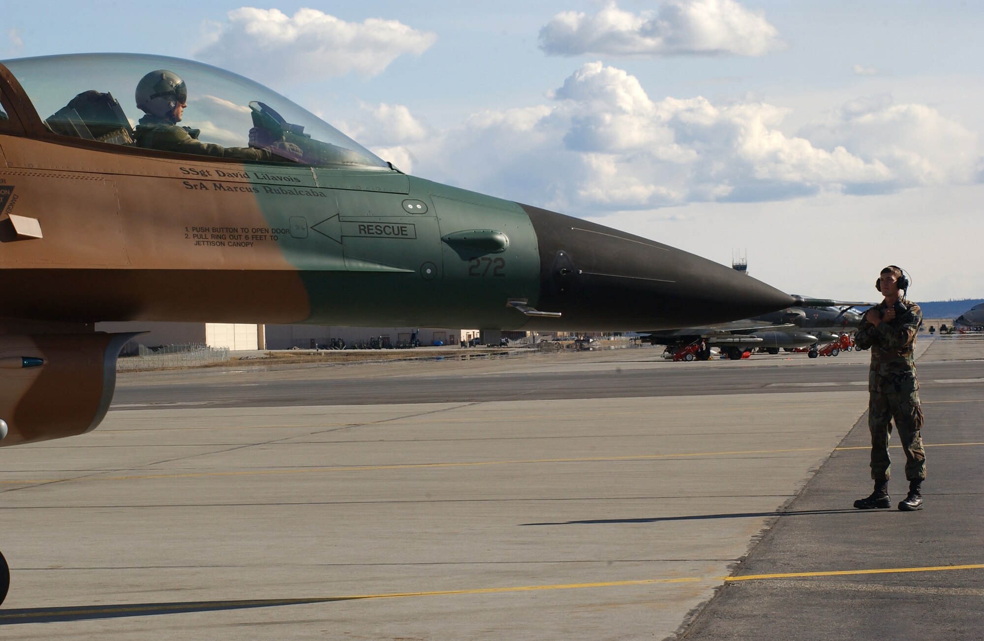 EIELSON AIR FORCE BASE, Alaska -- Senior Airman Marcus Rubalcaba, 57th Aircraft Maintenance Squadron, Nellis AFB, Nevada, marshals an F-16 Fighting Falcon, 64th Aggressor Squadron on April 16 for Red Flag-Alaska 07-1. The Aggressors play a vital role as the "Hostile Forces" for the exercise which helps the units to sharpen their combat skills by flying ten simulated combat sorties in a realistic threat environment.  (U.S. Air Force Photo by Staff Sgt. Tia Schroeder) 