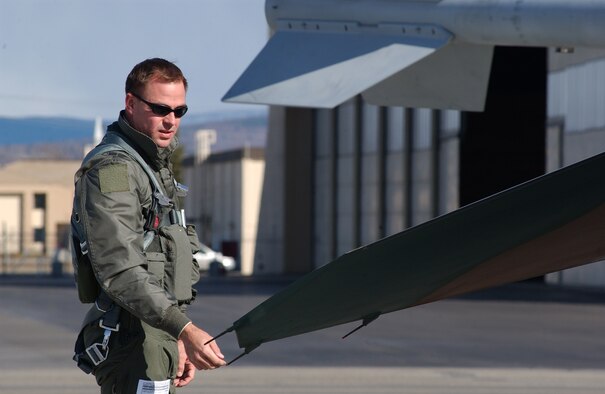 EIELSON AIR FORCE BASE, Alaska -- Capt. Jonathan Mumme, 64th Aggressor Squadron, Nellis Air Force Base, Nevada, conducts a pre-flight inspection on his F-16 Fighting Falcon prior to a mission during Red Flag-Alaska 07-1 on April 16. Red Flag-Alaska is a Pacific Air Forces-directed field training exercise for U.S. forces flown under simulated air combat conditions. It is conducted on the Pacific Alaskan Range Complex with air operations flown out of Eielson and Elmendorf Air Force Bases.  (U.S. Air Force Photo by Staff Sgt Tia Schroeder) 