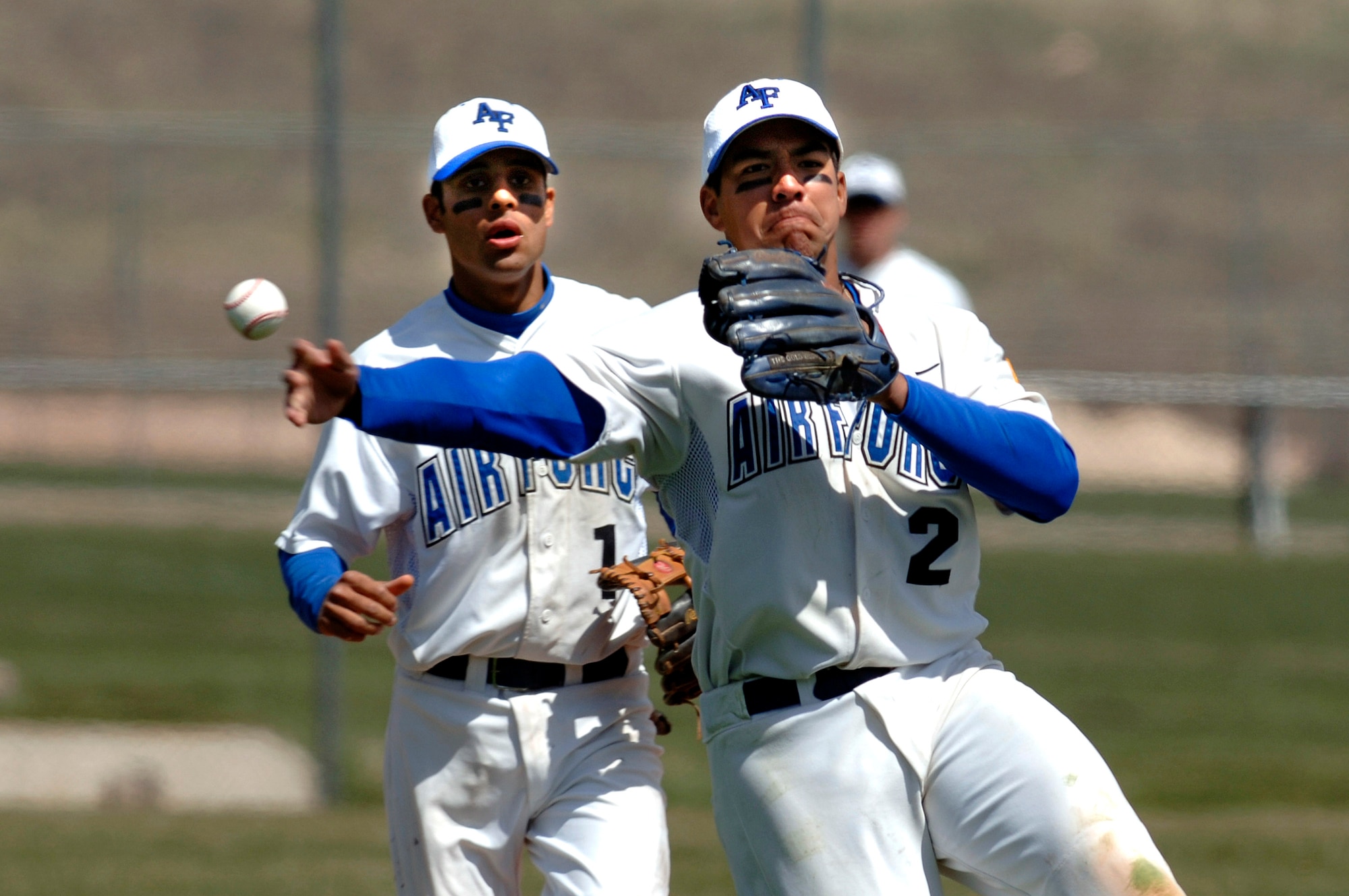 Senior second baseman Geno Salazar throws to first during a double play in game three of the 3-game series against the New Mexico Lobos.  New Mexico swept the 3-game series from the Air Force Falcons.   (U.S. Air Force photo/Mike Kaplan)