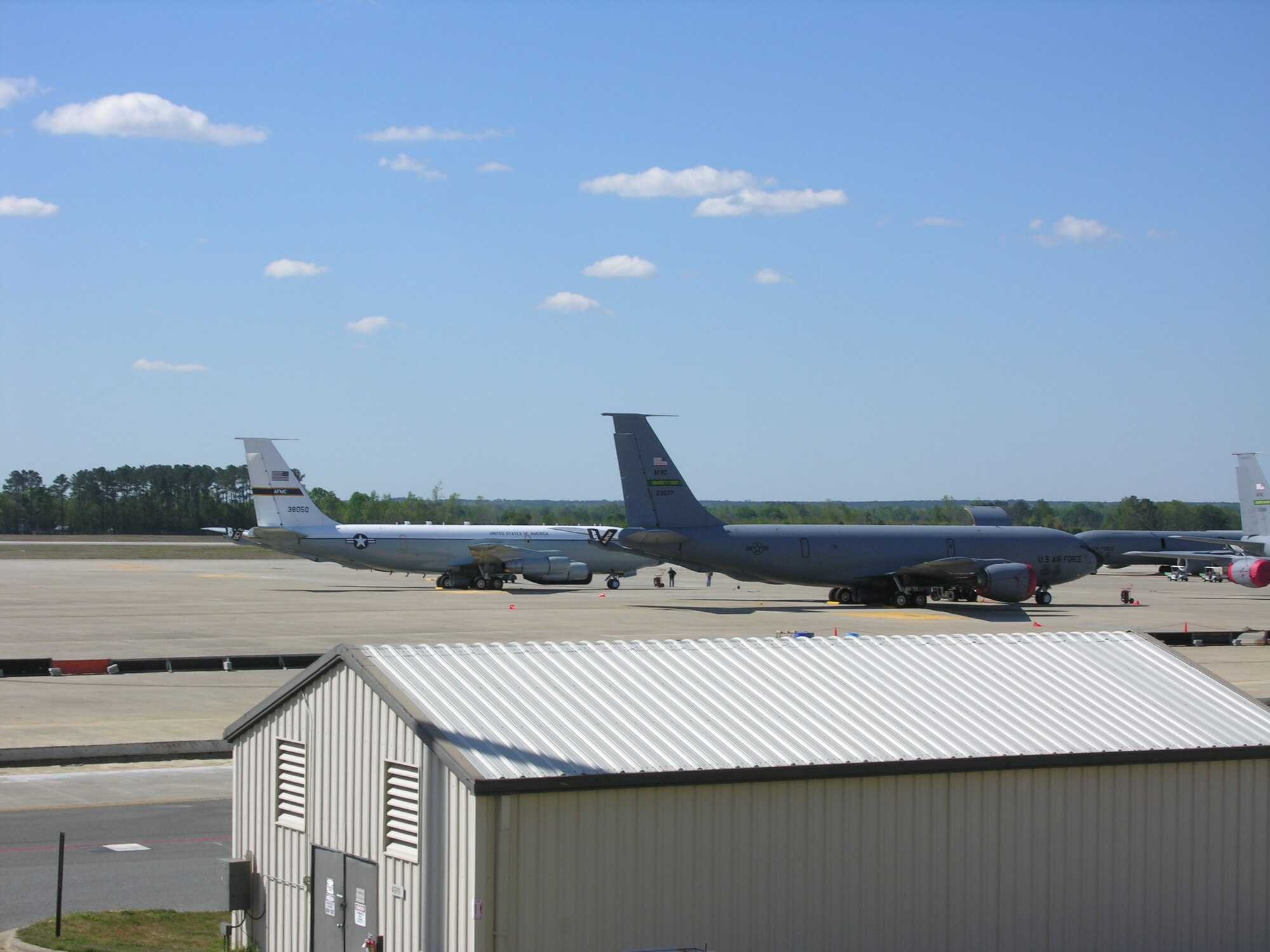 An aircraft from Kirtland Air Force Base, N.M. (left) enjoys a little ramp time after storms caused by the Nor'easter damaged its instruments causing an in-flight emergency on Tuesday. An aircrew from the 916th Air Refueling Wing, Air Force Reserve, helped the damaged aircraft land safely after launching a KC-135R Stratotanker to fly on its wing, assisting it in a visual landing. (U.S. Air Force photo/Capt. Shannon Mann)
          
