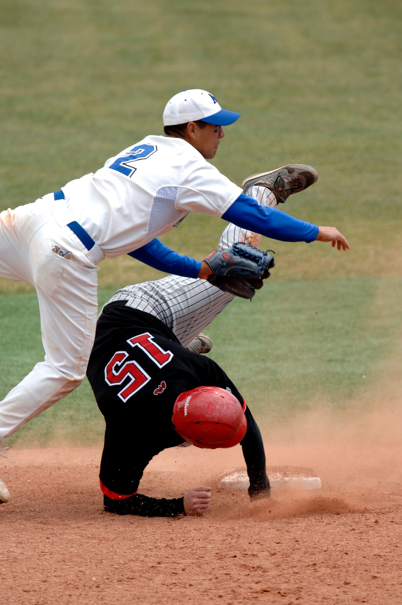 Senior second baseman Geno Salazar throws to first during a double play in game three of the 3-game series against the New Mexico Lobos.  New Mexico swept the 3-game series from the Air Force Falcons.   (U.S. Air Force photo/Mike Kaplan)