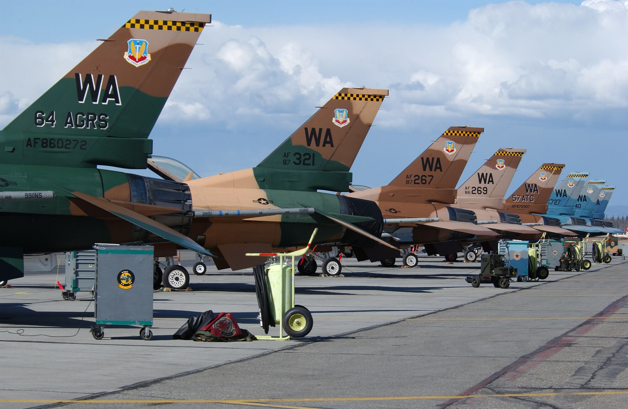EIELSON AIR FORCE BASE, Alaska -- Eight F-16 Fighting Falcons from the 64th Aggressor Squadron, Nellis AFB, Nevada sit in front of the Thunderdome on April 16 for Red Flag-Alaska 07-1. Red Flag-Alaska is a Pacific Air Forces-directed field training exercise for U.S. forces flown under simulated air combat conditions.  It is conducted on the Pacific Alaskan Range Complex with air operations flown out of Eielson and Elmendorf Air Force Bases.  (U.S. Air Force Photo by Staff Sgt. Tia Schroeder) 