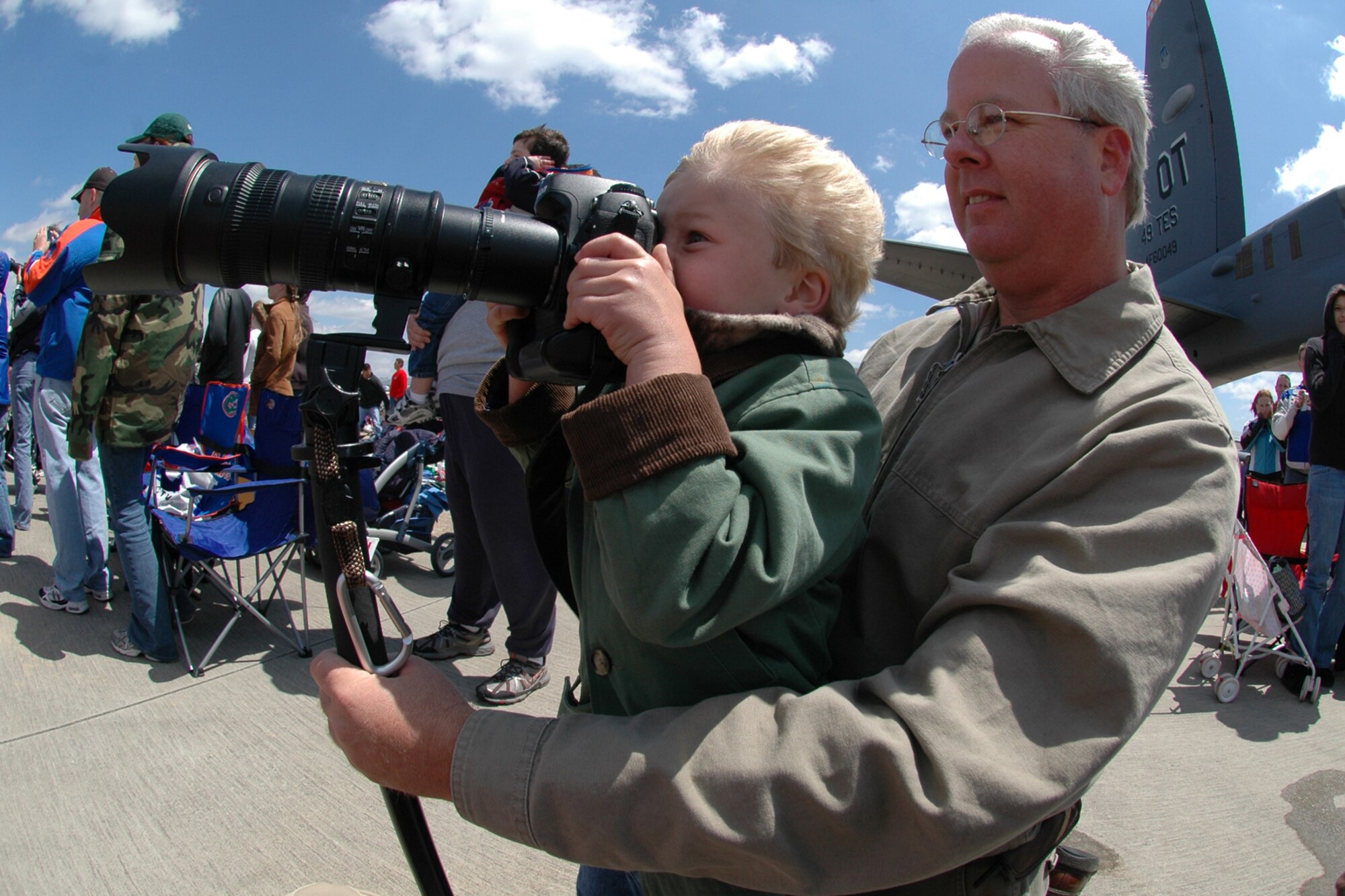 EGLIN AIR FORCE BASE, Fla. -- Mike Cage, of Crestview, teaches his son Greyson, 5, how to photograph the high speed action of the Thunderbirds during the 2007 Eglin Air Show April 15. The first day of the air show was cancelled due to severe weather coming into the area. Although the second day was cold and windy, thousands braved the elements to watch the aerial acrobatics in the skies over Eglin. (U.S. Air Force photo by Staff Sgt. Mike Meares)