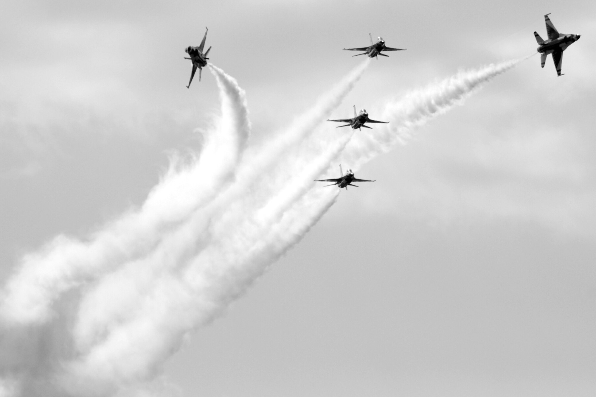 EGLIN AIR FORCE BASE, Fla. -- The U.S. Air Force Thunderbirds break for a "low bomb burst" maneuver in front of more than 42,000 spectators during the 2007 Eglin Air Show here April 15. The Thunderbirds' performance concluded the air show weekend that was cut show by a severe weather cancellation. The first day of the air show was cancelled for safety reasons due to a severe weather threat. The winds and cold temperatures on the back side of the storm didn't keep spectators away April 15 as the Thunderbirds performance culminated the air show.   (U.S. Air Force photo by Staff Sgt. Mike Meares)