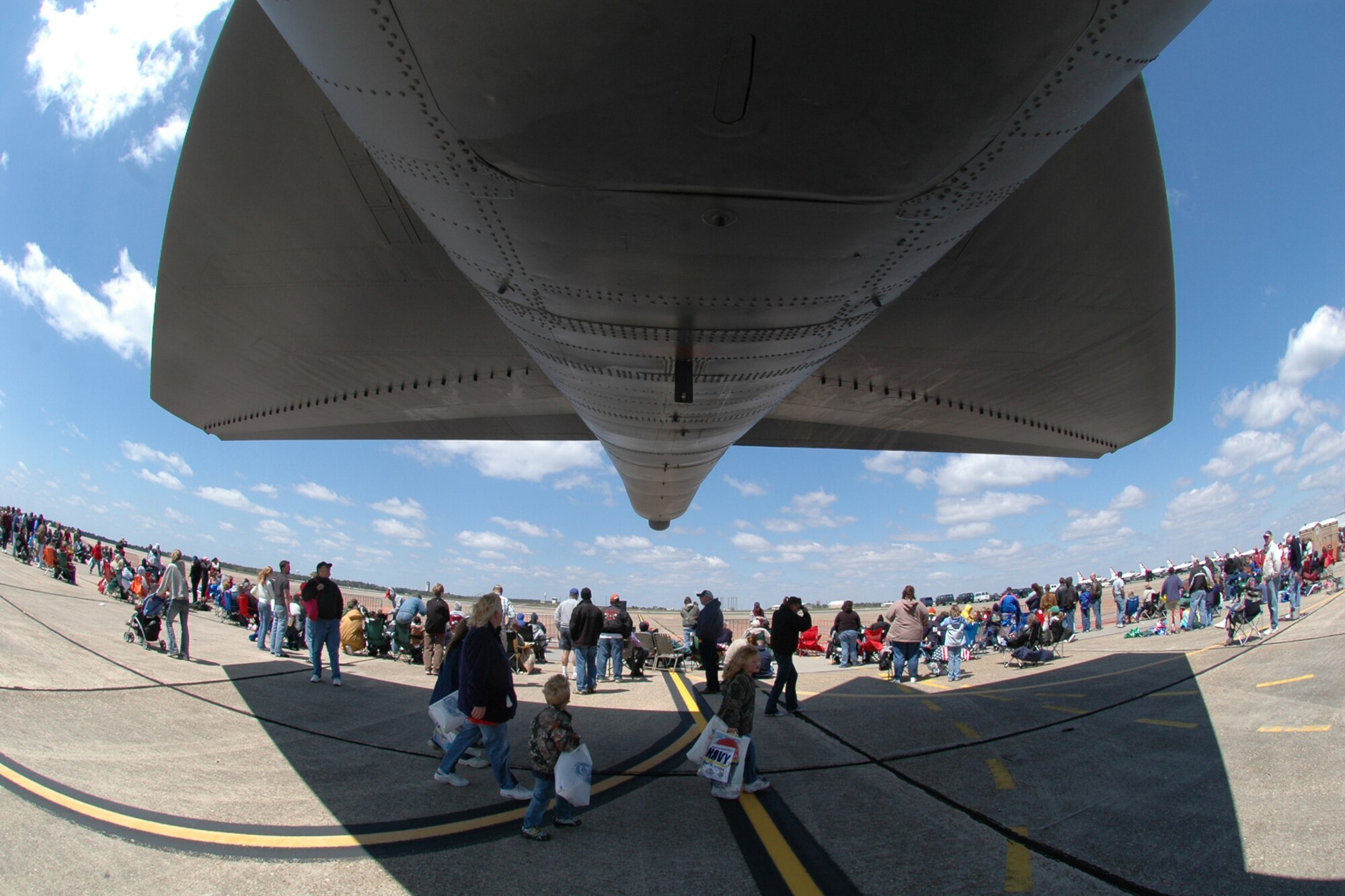 EGLIN AIR FORCE BASE, Fla. -- Spectators gather underneath the shadow of the B-52 Stratofortress bomber along the flighline in preparation for the 2007 Eglin Air Show demonstrations to begin. The first day of the air show was cancelled due to severe weather coming into the area. Although the second day was cold and windy, thousands braved the elements to watch the aerial acrobatics in the skies over Eglin. (U.S. Air Force photo by Staff Sgt. Mike Meares)