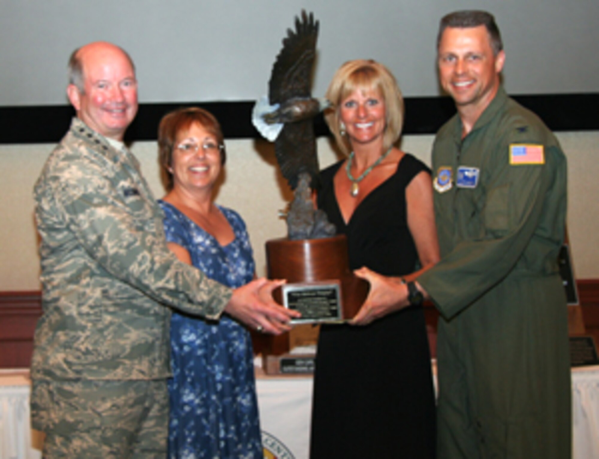 FAIRCHILD AIR FORCE BASE, Wash. – Gen. Duncan J. McNabb, Air Mobility Command commander, and Col. Scott Hanson, 92nd Air Refueling Wing commander, and their wives, Linda and Rhonda respectively, pose with the Abilene Trophy. During Phoenix Rally at MacDill AFB, Fla., it was announced the Spokane Community is the 2006 Abilene Trophy recipient. The trophy recognizes the community that provides the finest support to an AMC installation. The award is presented annually, providing recognition for activities conducted between January and December of the preceding year.
