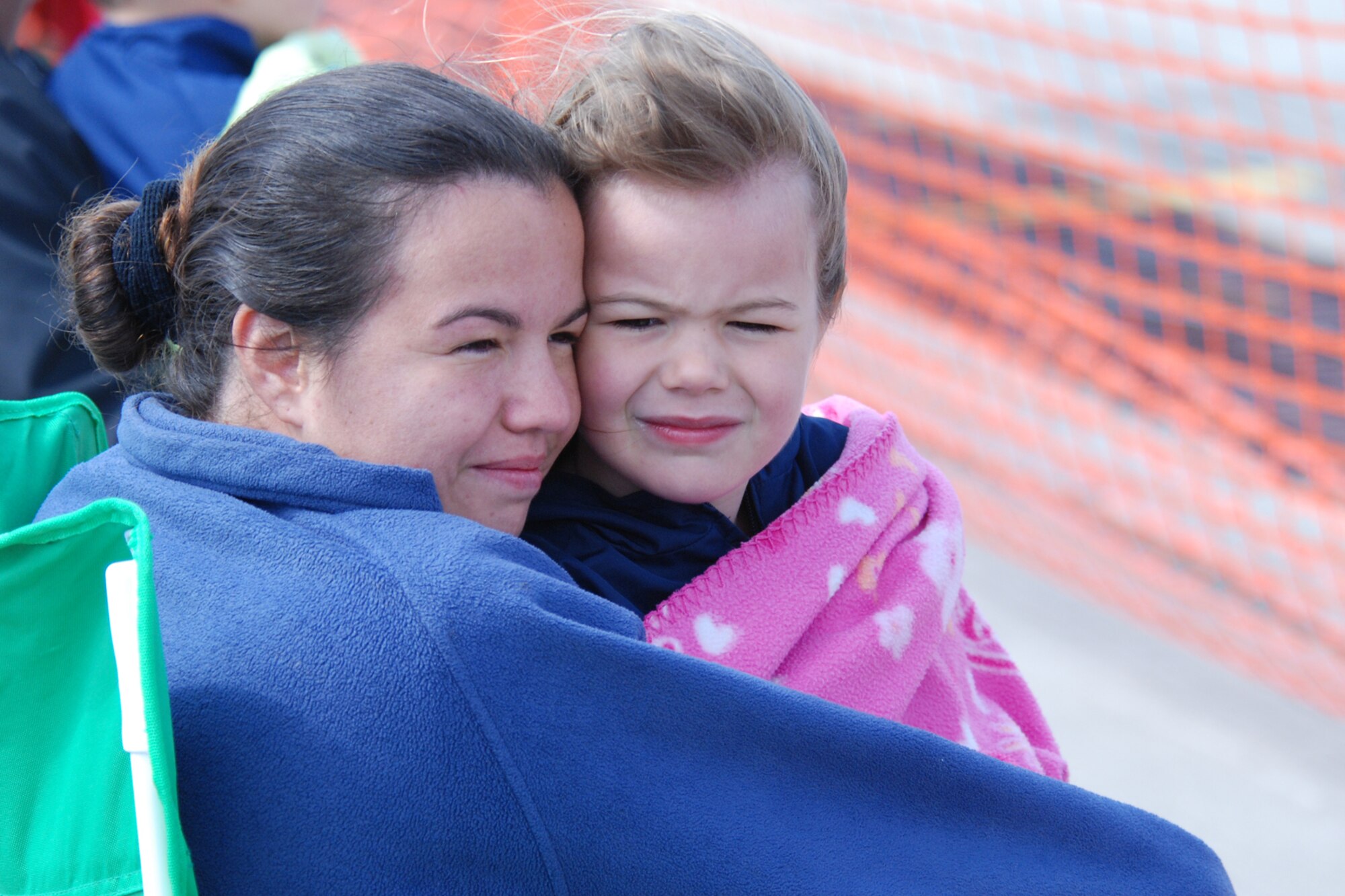 EGLIN AIR FORCE BASE, Fla. -- Stacey Spurlock, and her daughter Hannah, 5, both Eglin residents, bundle up underneath blankets April 15 during the 2007 Eglin Air Show. The first day of the air show was cancelled due to severe weather coming into the area. Although the second day was cold and windy, more than 42,000 spectators braved the elements to watch the aerial acrobatics in the skies over Eglin. (U.S. Air Force photo by Staff Sgt. Mike Meares)