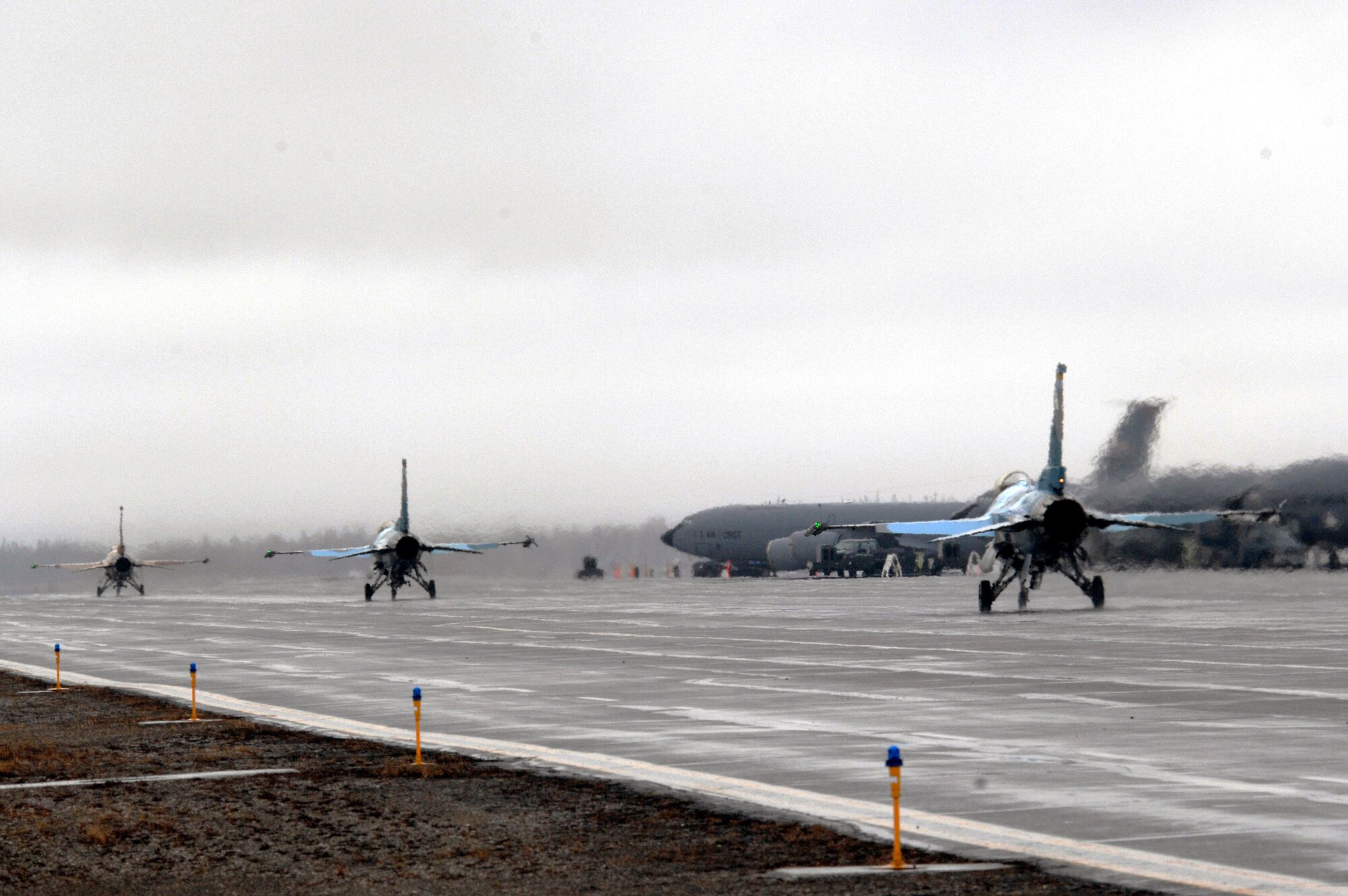 Three F-16 Fighting Falcons from the 64th Aggressor Squadron, Nellis Air Force Base, Nev., taxi for take off April 12 during Red Flag-Alaska 07-1 at Eielson AFB, Alaska. Red Flag-Alaska is a Pacific Air Forces-directed field training exercise for U.S. forces flown under simulated air combat conditions. It is conducted on the Pacific Alaskan Range Complex with air operations flown out of Eielson and Elmendorf Air Force Bases. (U.S. Air Force photo/Staff Sgt. Joshua Strang)
