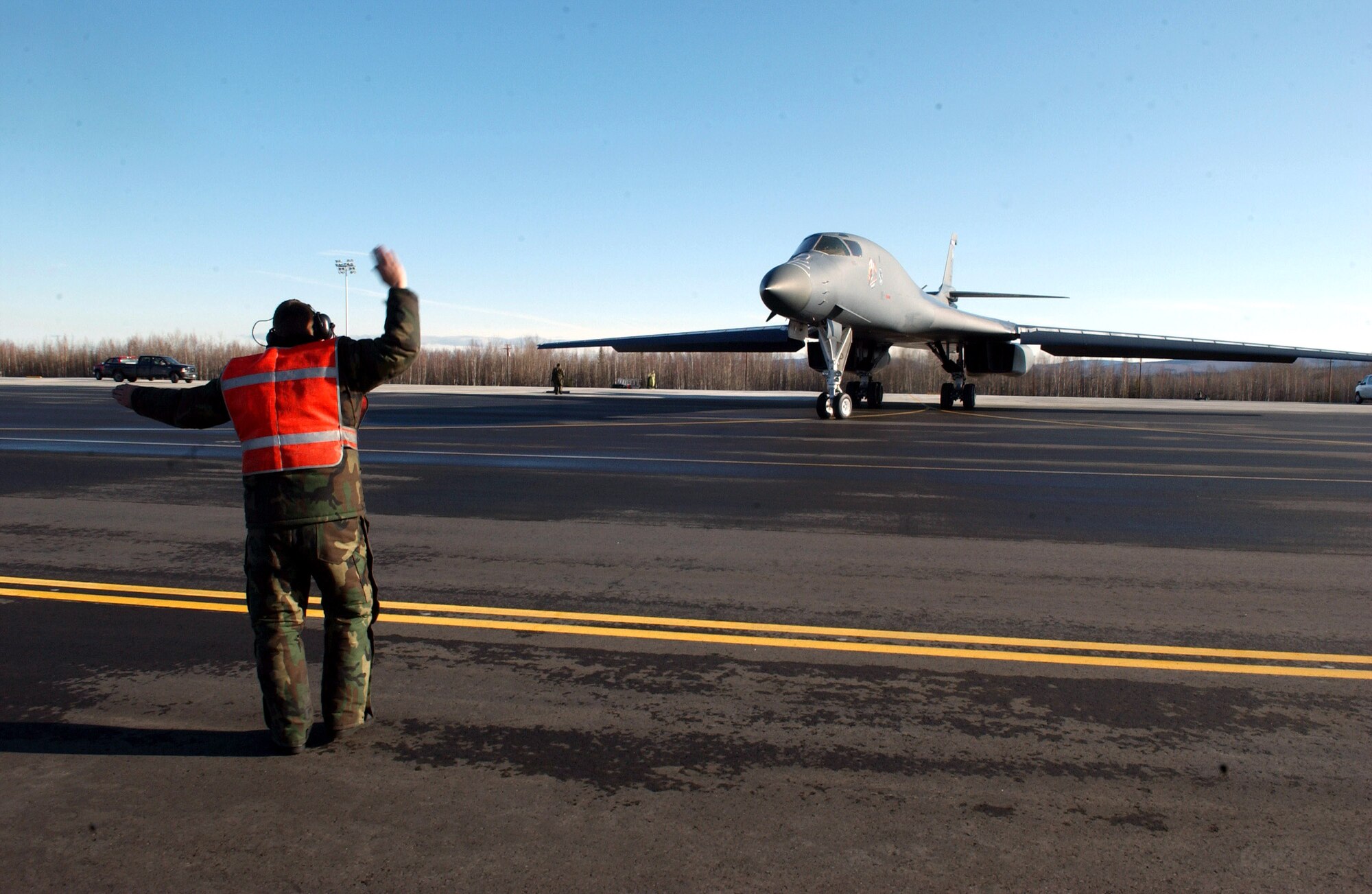 Senior Airman Michael Anderson marshals a B-1B Lancer April 13 at Eielson Air Force Base, Alaska, during Red Flag-Alaska 07-1. Red Flag-Alaska is a Pacific Air Forces-directed field training exercise for U.S. forces flown under simulated air combat conditions. It is conducted on the Pacific Alaskan Range Complex with air operations flown out of Eielson and Elmendorf Air Force Bases. Airman Anderson is assigned to the 28th Aircraft Maintenance Squadron at Ellsworth AFB, S.D. (U.S. Air Force photo/Airman 1st Class Jonathan Snyder)