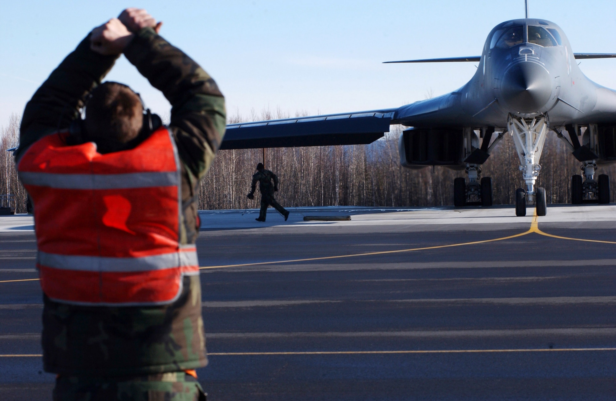 Senior Airman Michael Anderson marshals a B-1B Lancer April 13 at Eielson Air Force Base, Alaska, during Red Flag-Alaska 07-1. Red Flag-Alaska is a Pacific Air Forces-directed field training exercise for U.S. forces flown under simulated air combat conditions. It is conducted on the Pacific Alaskan Range Complex with air operations flown out of Eielson and Elmendorf Air Force Bases. Airman Anderson is assigned to the 28th Aircraft Maintenance Squadron at Ellsworth AFB, S.D. (U.S. Air Force photo/Airman 1st Class Jonathan Snyder)