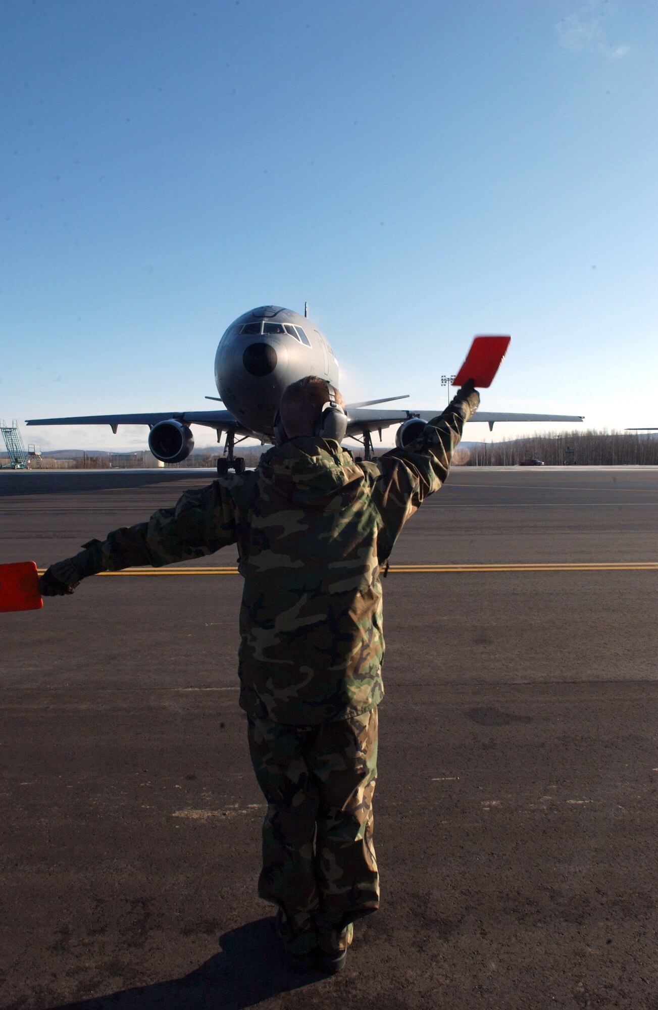 Staff Sgt. Martin Walker marshals a KC-10 Extender April 13 at Eielson Air Force Base, Alaska, during Red Flag-Alaska 07-1. This aircraft supports Red Flag-Alaska by performing aerial refueling allowing longer flight time for fighter jets conducting simulated air combat training missions over the Pacific Alaskan Range Complex. Sergeant Walker is assigned to the 305th Maintenance Squadron at McGuire AFB, N.J. (U.S. Air Force photo/Airman 1st Class Jonathan Snyder)