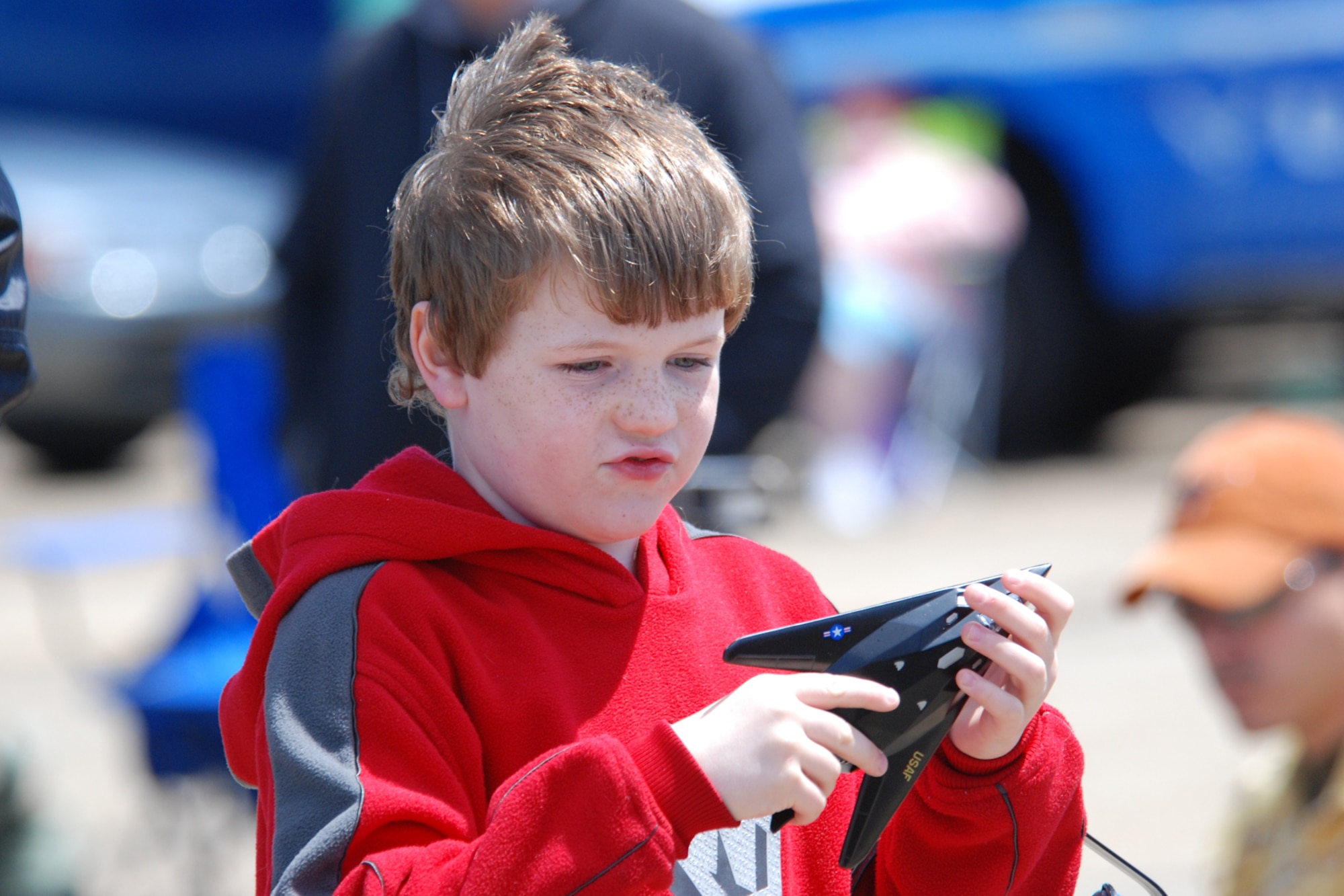EGLIN AIR FORCE BASE, Fla. -- Luke McCaleb, 8, from Dora, Ala., plays with his toy F-117 Stealth fighter during the 2007 Eglin Air Show April 15. Luke joined his father along with a couple of friends and drove more than five hours to see the show. The first day of the air show was cancelled due to severe weather coming into the area. Although the second day was cold and windy, more than 42,000 spectators braved the elements to watch the aerial acrobatics in the skies over Eglin. (U.S. Air Force photo by Staff Sgt. Mike Meares)