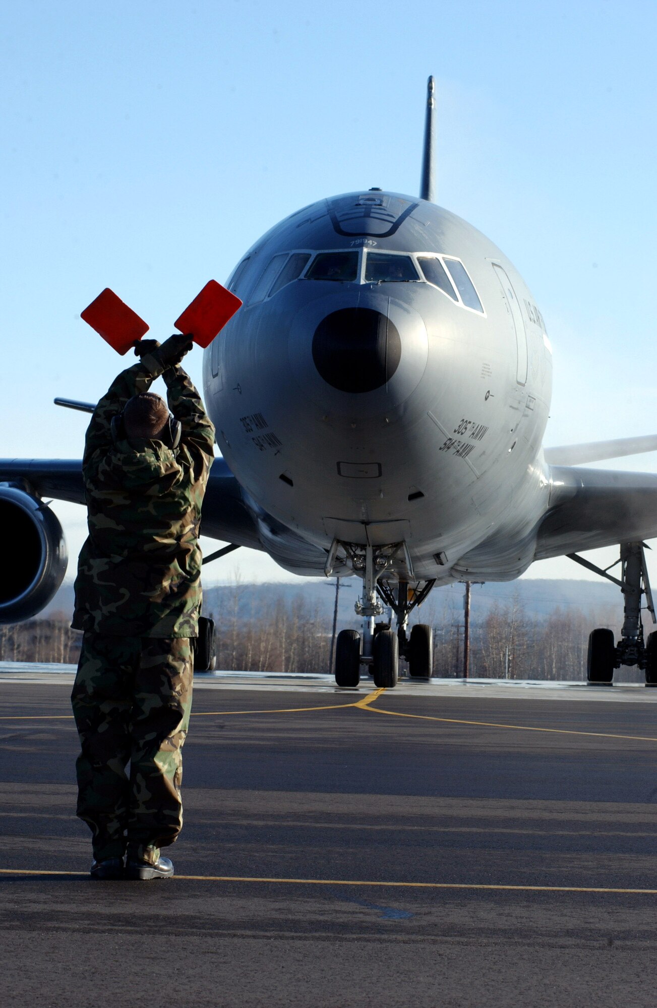 Staff Sgt. Martin Walker proceeds into place to marshal a KC-10 Extender April 13 during Red Flag-Alaska 07-1 at Eielson Air Force Base, Alaska. Red Flag-Alaska is a Pacific Air Forces-directed field training exercise for U.S. forces flown under simulated air combat conditions. It is conducted on the Pacific Alaskan Range Complex with air operations flown out of Eielson and Elmendorf Air Force Bases. Sergeant Walker is assigned to the 305th Maintenance Squadron at McGuire AFB, N.J. (U.S. Air Force photo/Airman 1st Class Jonathan Snyder)