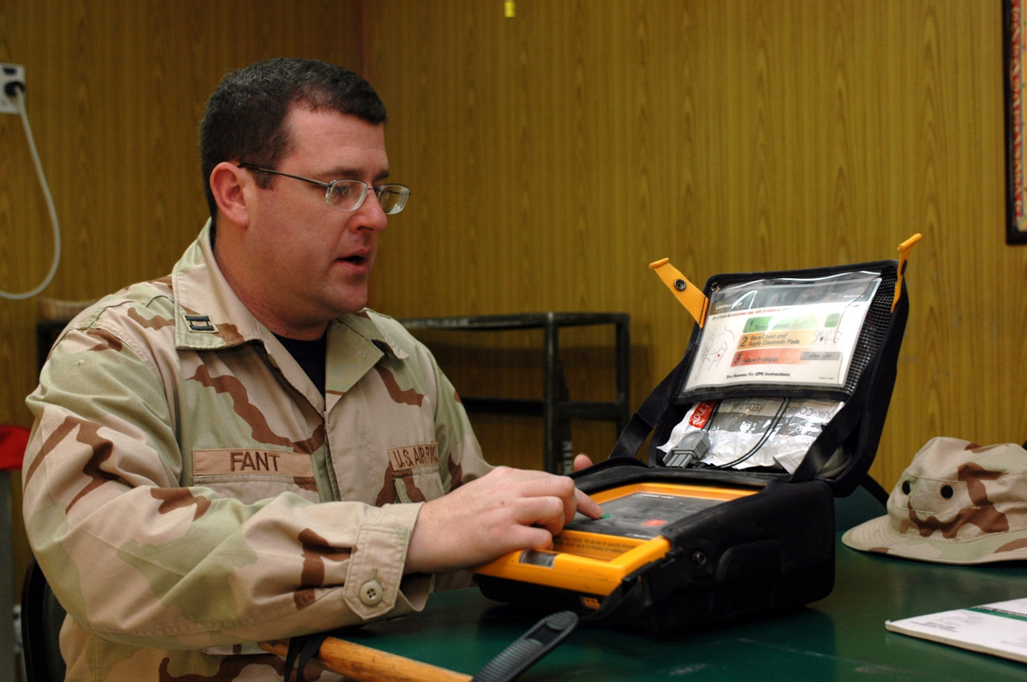 Capt. James Fant performs a weekly inspection of the automated external defibrillator at the Independence Dining Facility April 11 in Southwest Asia. The shock delivered by an AED helped save an Airman's life recently. Captain Fant is a 379th Expeditionary Medical Group clinical nurse. (U.S. Air Force photo/Senior Airman Erik Hofmeyer)