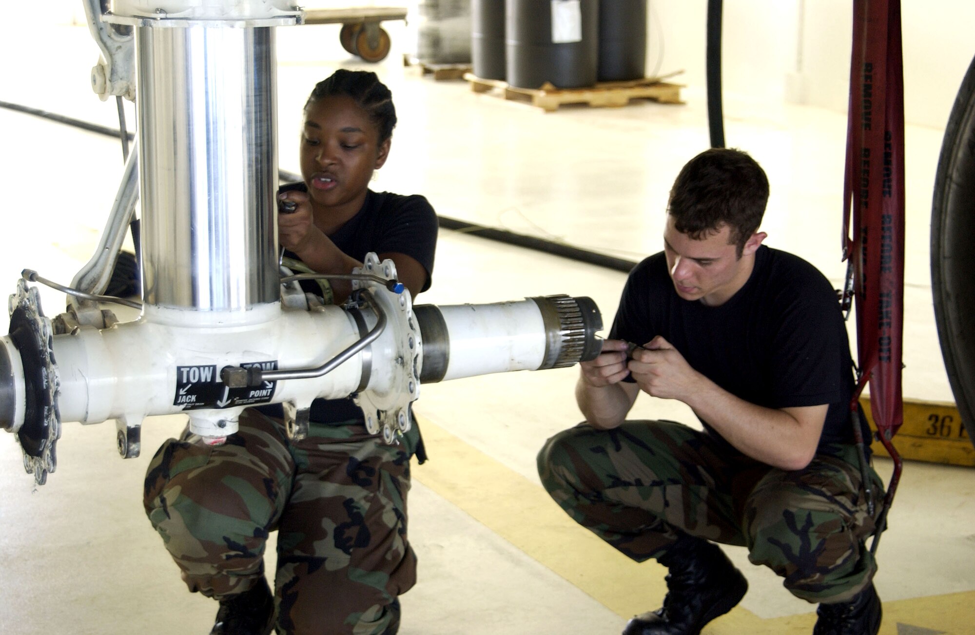 Airman 1st Class Alacia Lane and Senior Airman Ian Murphy complete a gear repack on the front landing gear of a B-52 Stratofortress deployed to Andersen Air Force Base, Guam. The 36th Expeditionary Aircraft Maintenance Squadron has compiled an impressive 84.2 percent mission capable rate while deployed to Guam, higher than the 76 percent mission standard expected back at the unit's home station at Barksdale Air Force Base, La. The Airmen are deployed with the 36th EAMXS. (U.S. Air Force photo/Senior Master Sgt. Don Perrien)