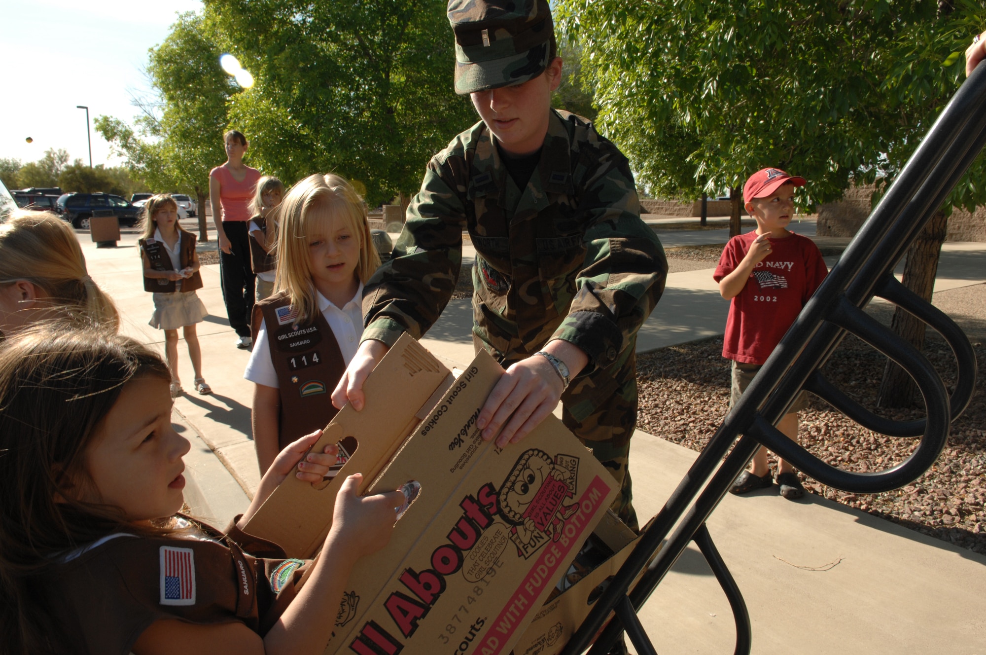 Brownie troop #114 help 1Lt. Rose Killingsworth, 474th Operations Group, unload just part of a total of 250 boxes of Girl Scout cookies donated by the Girl Scouts of the USA, Old Vail Service Unit, at Headquarters Twelfth Air Force, April 4.  The cookies will be delivered by Twelfth Air Force and Air Forces Southern to deployed Airmen as well as various orphanages and organizations in the Air Forces Southern Area of responsibility, which includes Central and South America and the Caribbean. 