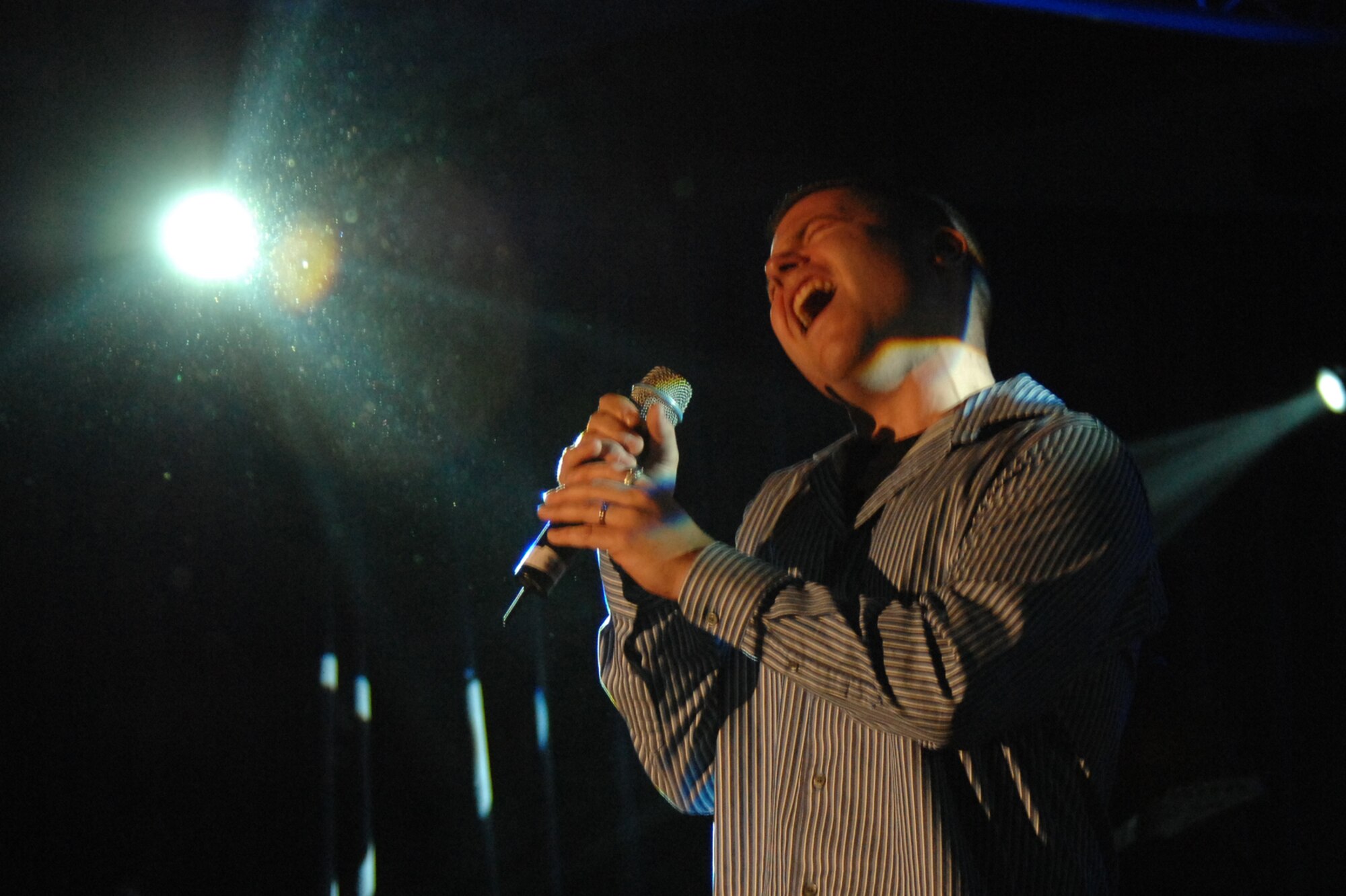 Staff Sgt. Jeff Nevison performs for a crowd of 500 during the U.S. Air Forces in Europe Idol contest on April 14, at Ramstein Air Base, Germany.  Staff Sgt. Nevison wowed the crowed as he opened with “I’ll Be” by Edwin McCain and then sang “Open Arms” by Journey to finish his idol experience as the new USAFE Idol.  (U. S. Air Force photo by Senior Airman Levi Riendeau)(RELEASED)