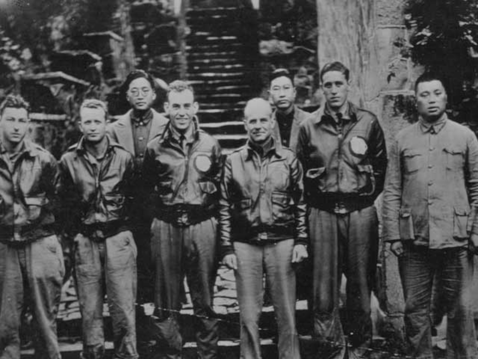 Major General Doolittle, his Tokyo bombing crew and some Chinese friends are pictured in China after the US Airmen bailed out following the Doolittle led air raid on Japan. Left to right, Staff sgt. F.A. Braemer, bombardier, Seattle; Staff Sgt. P.J. Leonard, Engineer-Gunner, Denver, unidentified Chinese; First Lt. R.E. Cole. Co-Pilot, Dayton, Ohio, General Doolittle; unidentified Chinese; First Lt. H.A. Potter, Navigator, Pierre, South Dakota; unidentified Chinese; Sgt. Leonard was killed in action in North America. (National Archives, US Navy 80-G-063592).