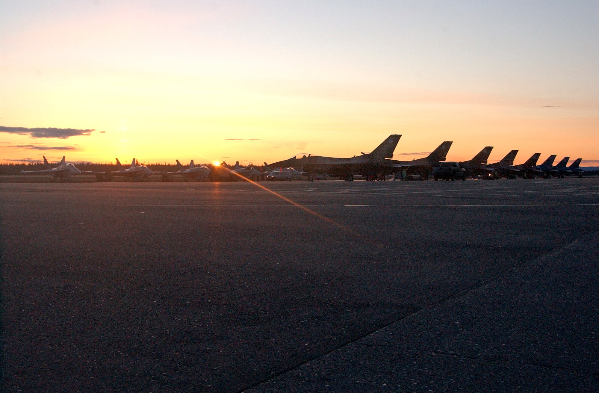 EIELSON AIR FORCE BASE, Alaska--The sun sets on a group of Navy F/A-18 Hornets from the Strike Fighter Squadron Eight Seven (VFA-87)  64th Aggressor Squadron, and F-16 Fighting Falcons from Nellis Air Force Base, Nevada, F-16 Fighting Falcons during Red Flag-Alaska 07-1. Red Flag-Alaska is a Pacific Air Forces-directed field training exercise for U.S. forces flown under simulated air combat conditions. It is conducted on the Pacific Alaskan Range Complex with air operations flown out of Eielson and Elmendorf Air Force Bases. (U.S. Air Force photo by Senior Airman Justin Weaver).