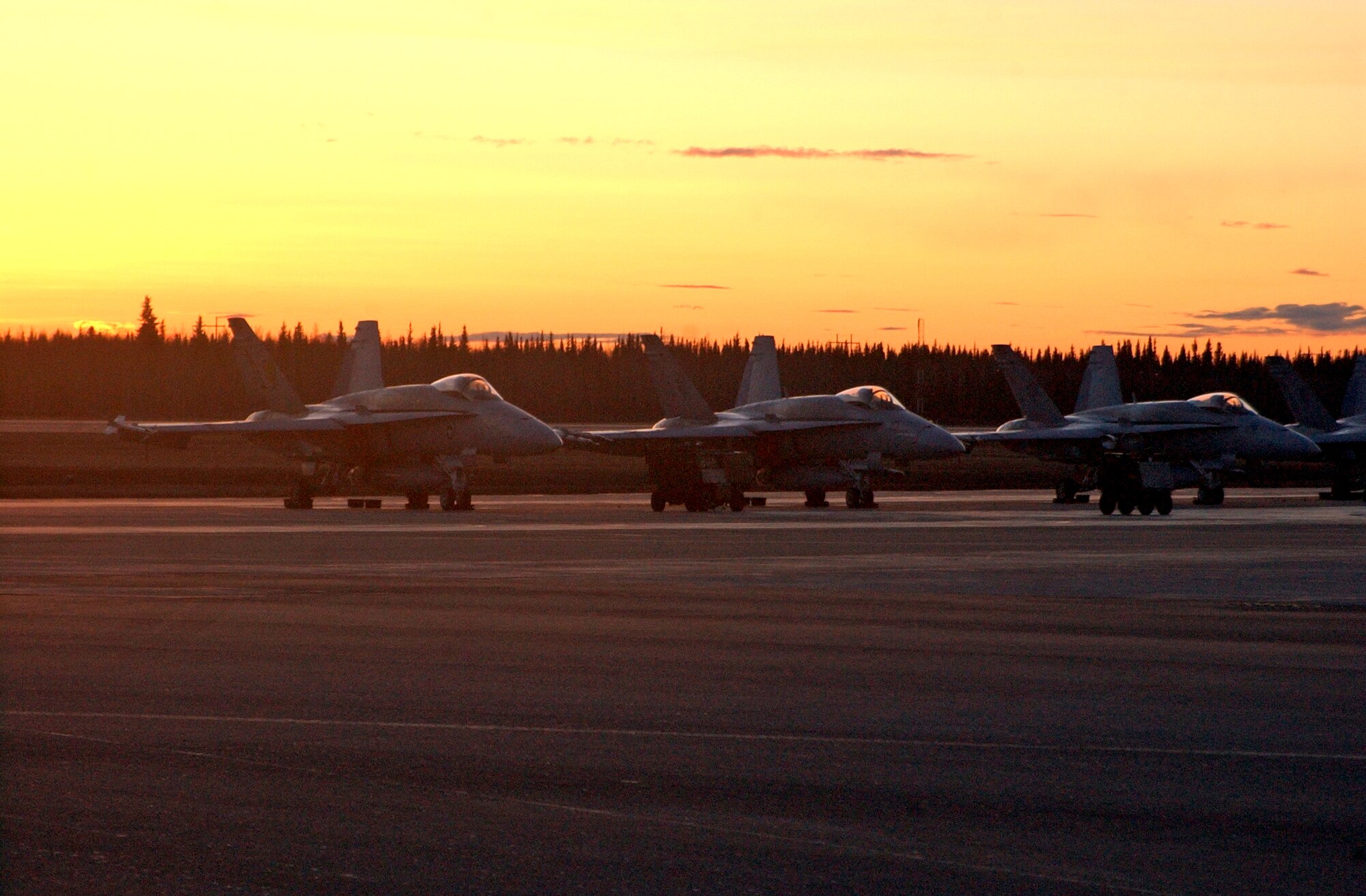 EIELSON AIR FORCE BASE, Alaska--The sun sets on a group of Navy F/A-18 Hornets from the Strike Fighter Squadron Eight Seven (VFA-87) during Red Flag-Alaska 07-1 here on April 16. VFA-87 is based at Naval Air Station Oceana, Virginia. More than 1,300 military members from the United States, France and Australia have gathered in the Last Frontier to participate in Red Flag-Alaska 07-1 scheduled from April 5 to 21. (U.S. Air Force photo by Senior Airman Justin Weaver).