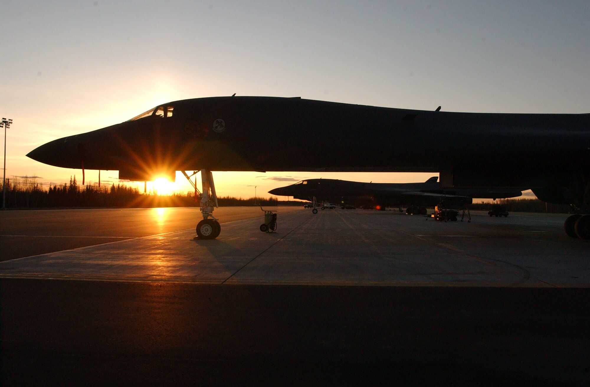 EIELSON AIR FORCE BASE, Alaska--The sun sets on a group of B-1B Lancers from Ellsworth Air Force Base, South Dakota, on the flightline here April 16 during Red Flag-Alaska 07-1. Red Flag-Alaska enables aviation units to sharpen their combat skills by flying ten simulated combat sorties in a realistic threat environment. Additionally, the training allows them to exchange tactics, techniques, and procedures and improve interoperability. (U.S. Air Force photo by Senior Airman Justin Weaver). 