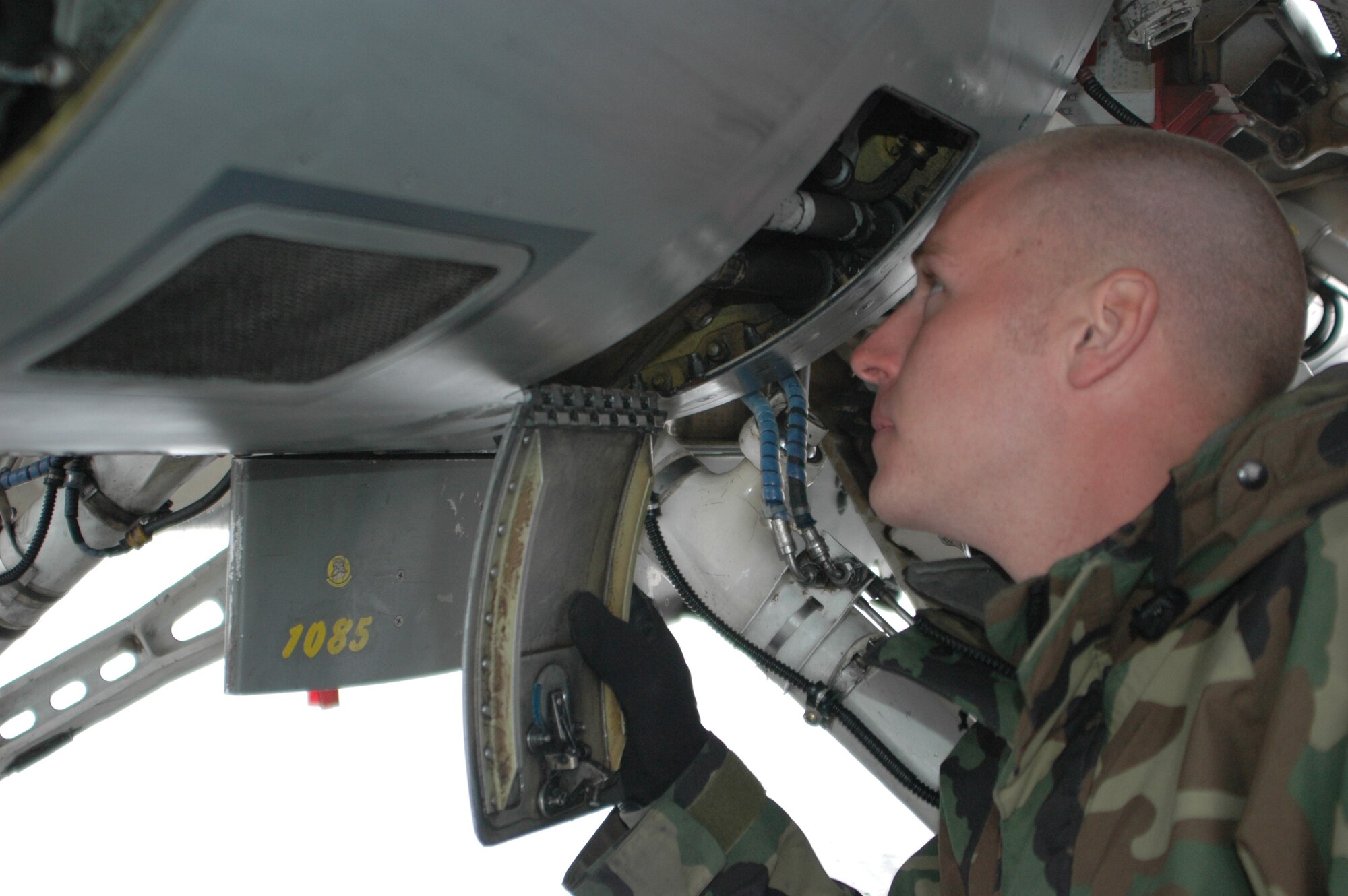 EIELSON AIR FORCE BASE, Alaska--Senior Airman Richard Adamowich, 61st Fighter Squadron F-16 avionics journeyman, Luke AFB, Ariz., does preflight inspections on an F-16 April 13 here on the flightline. Airmen from the 61st FS are at Eielson in support of Red Flag-Alaska, a multi-service, multi-platform, combat-operations exercise involving the coalition forces of France and Australia. (U.S. Air Force photo by Airman 1st Class Nora Anton)