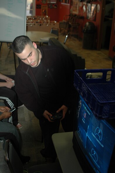 Airman Julio Perez, 28th Security Forces Squadron commander’s support staff, checks to see if the game systems were connected properly through the LAN for the April 13 Halo 2 team tournament at the Black Hills Community Center. The tournament pitted eight teams of two against one another in an all out battle royal. (U.S. Air Force photo/Airman Nathan Riley)