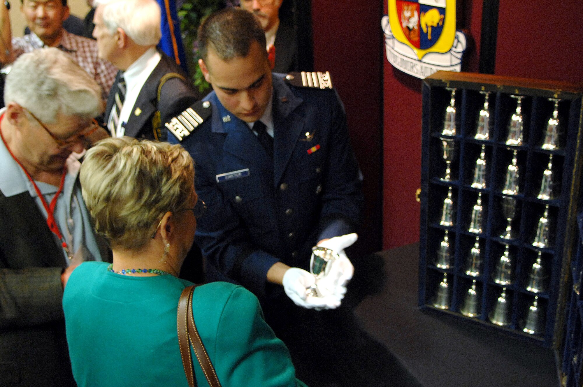 Air Force Academy Cadet 1st Class Michael Carter shows Connie McClure the goblet of her father-in-law, Charles L. McClure, after a goblet ceremony in San Antonio April 18. There are 80 goblets representing each of the Doolittle Raiders. When a Raider dies, his goblet is turned over in the case. When there are but two Raiders left, the two men will open a bottle of cognac, vintage 1896 (the year Doolittle was born) and give a final toast to their departed comrades. Fourteen of the 80 Raiders are still alive. (U.S. Air Force photo/Staff Sgt. Brian Ferguson)