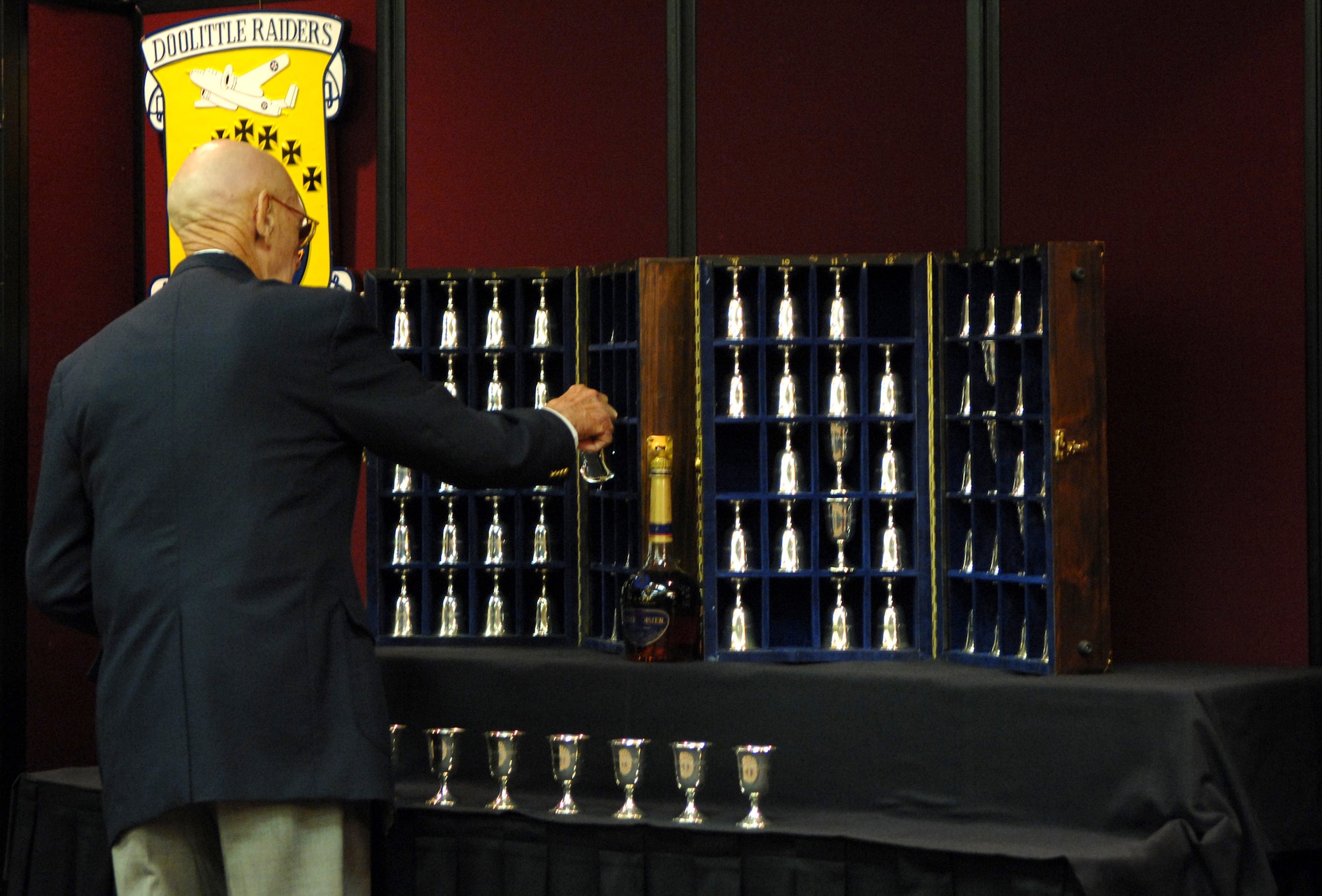 Retired Lt. Col. Dick Cole turns over the goblet of Lt. Col. Chase Nielson, a Doolittle Raider who died March 23, during a goblet ceremony in San Antonio April 18. When a Raider dies, his goblet is turned upside down. When there are but two Raiders left, the two men will open a bottle of cognac, vintage 1896 (the year Doolittle was born) and give a final toast to their departed comrades. Fourteen of the 80 Raiders are still alive. (U.S. Air Force photo/Staff Sgt. Brian Ferguson) 