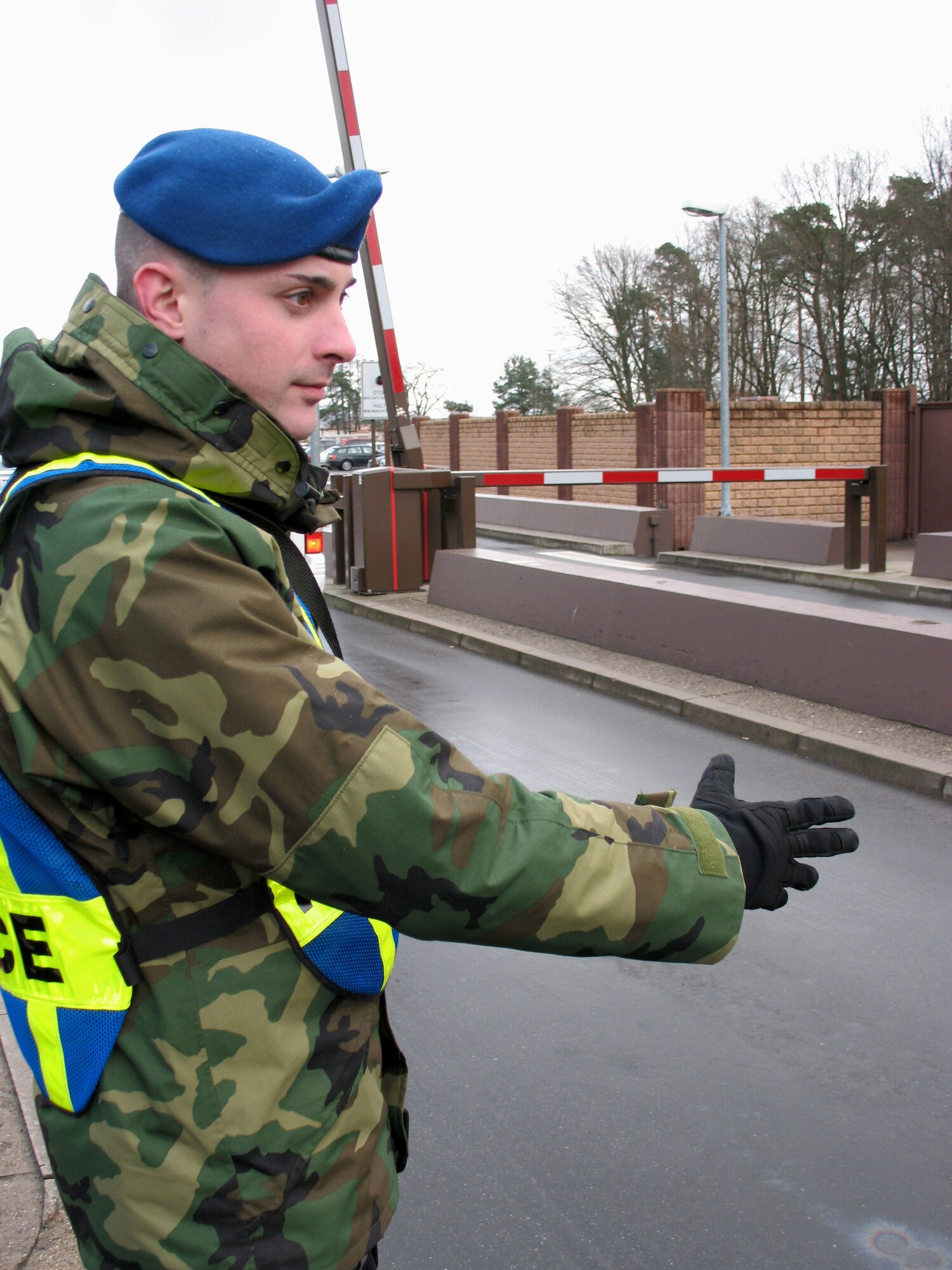 German civilian security police member, ZP-3 Mark Beysiegel, helps traffic run smoothly into Ramstein Air Base, Germany. ZPs are fully integrated into security forces flights, working side by side, and in some cases, training Airmen. (U.S. Air Force photo/Staff Sgt. Jason David)
