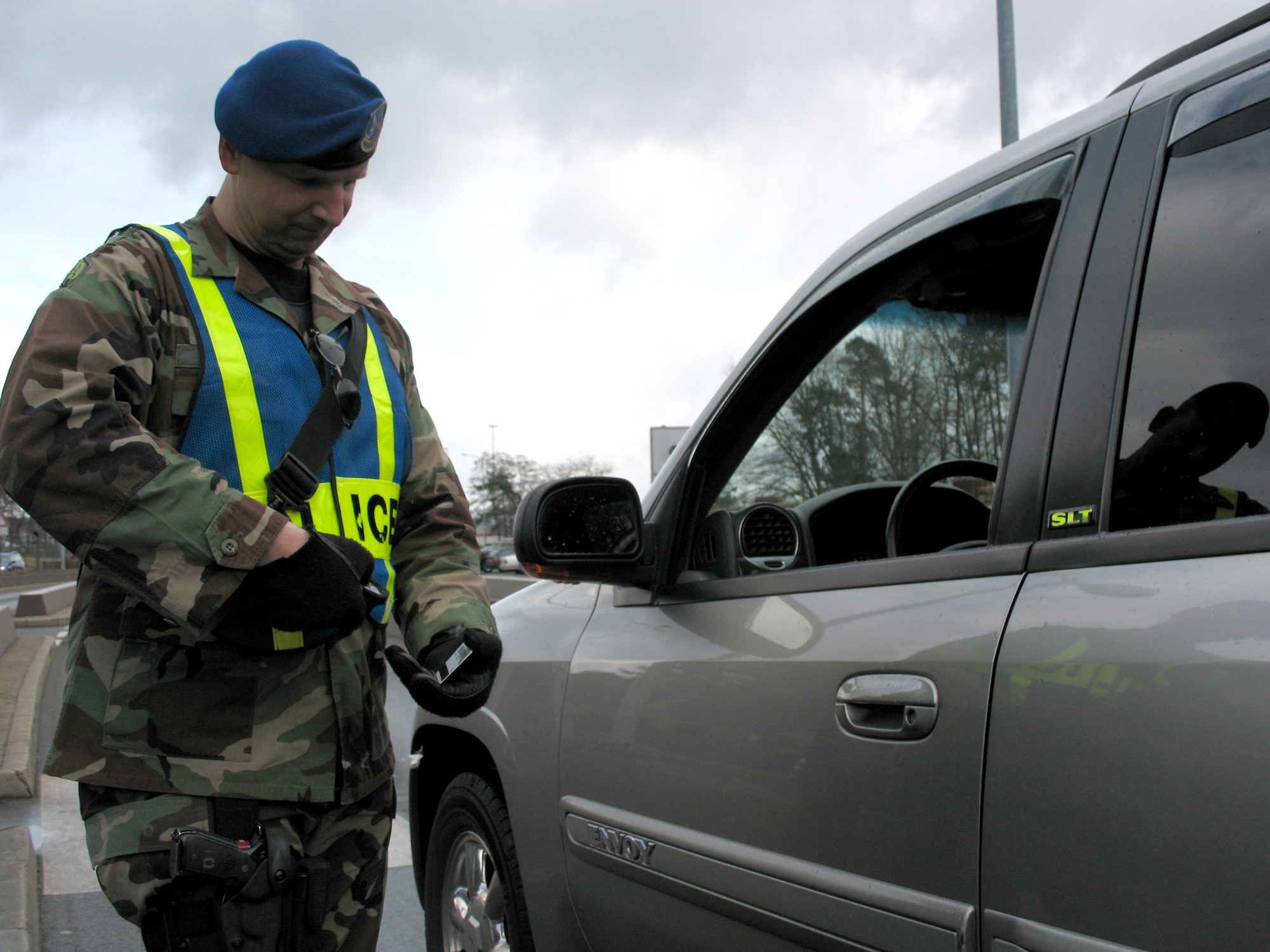 German civilian security police member, ZP-3 Oliver Kopp, checks an ID at the gate of Ramstein Air Base, Germany. With the high deployment rate of their military counterparts, the ZPs have stepped up to make sure there are no gaps in safeguarding security. (U.S. Air Force photo/Staff Sgt. Jason David) 
