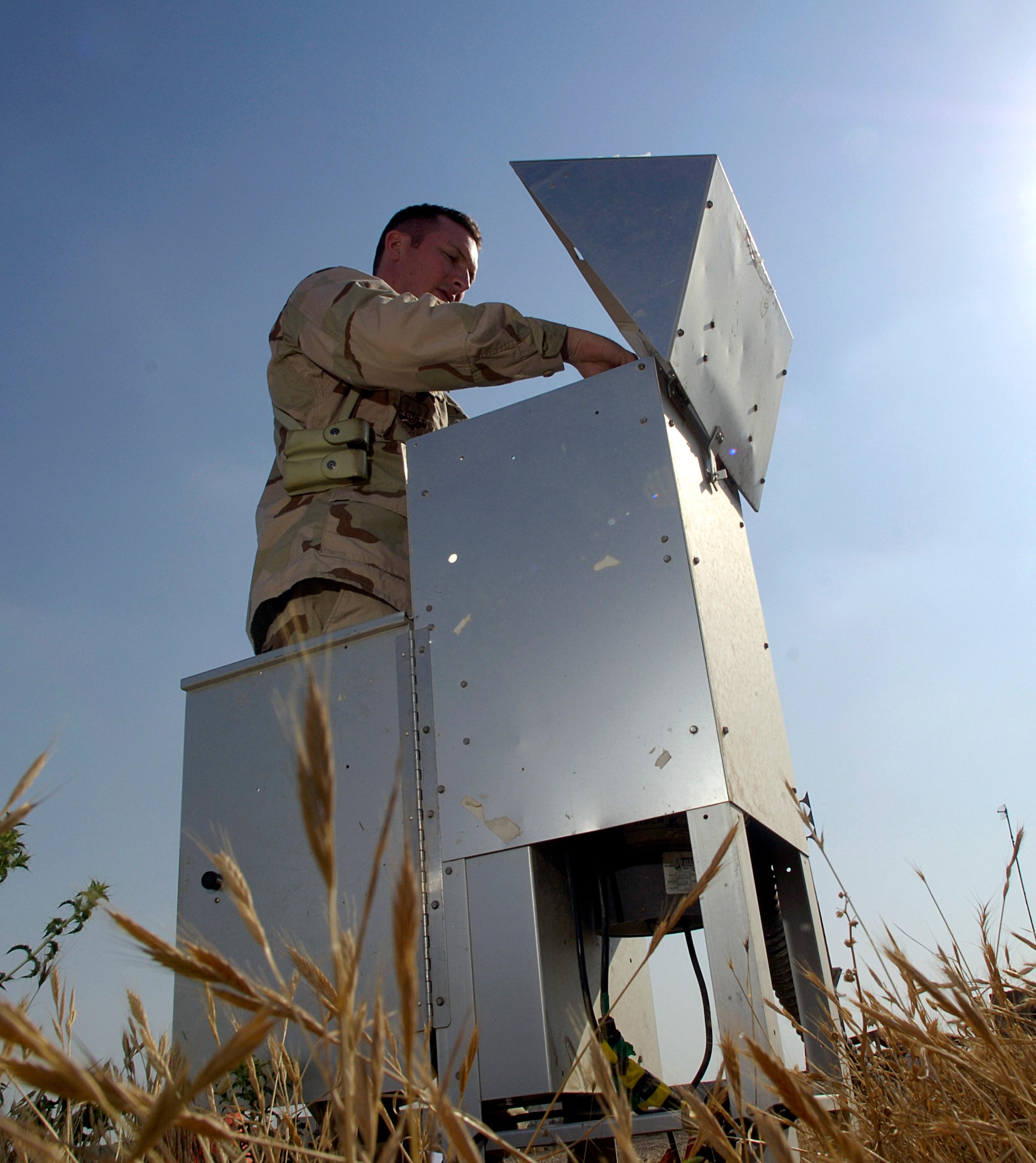 Capt. Charles Toth checks a monitoring device April 13 at Balad Air Base, Iraq, for common pesticides and other environmental hazardous chemicals in the air.  Captain Toth is the bioenvironmental engineer flight commander. Bioenvironmental engineers perform environmental, occupational and radiological surveillance in order to protect and maintain a healthy work force, and they serve as mission enhancers during emergency management response operations. (U.S. Air Force photo/Airman 1st Class Nathan Doza) 