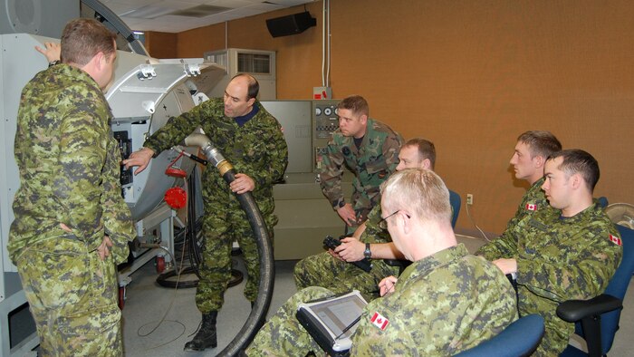 Cpl. Tim Parker, Royal Canadian Air Force 429th Squadron aviation technician, demonstrates how to refuel a C-17 in front of the class instructed by Staff Sgt. Gerrick Hoffman, 373rd Training Squadron Detachment 5 aircraft general instructor. (U.S. Air Force photo/Tech. Sgt. Christopher Prestero)