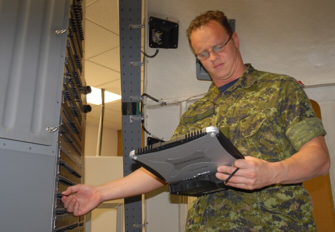 Cpl. Darrell Skinner, Royal Canadian Air Force 429th Squadron avionics technician, pulls circuit breakers on the Training Evlauation Performance Aircraft Training Set. (U.S. Air Force photo/Airman Melissa Harper)