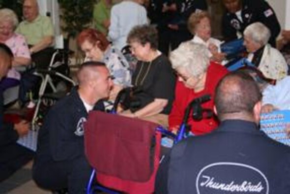 SHALIMAR, Fla. -- Members of the Thunderbirds, the Air Force’s air demonstration team, visit with residents at Hawthorn House, the Air Force Enlisted Village’s assisted living residence in Shalimar. When inclement weather caused the Eglin Air Show to be cancelled Saturday, the Thunderbirds made a surprise visit to the Enlisted Village, a charity that provides a home for the widows of enlisted servicepeople. (Photo by Jodi L. Jordan)