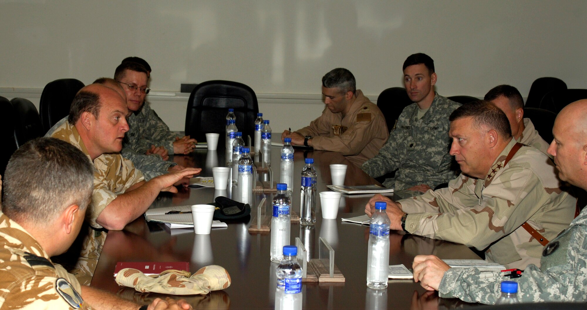 Col. Ed Brown, British Multinational Defense-Southeast Brigade Forward West commander (left center), explains his nation's role in the coalition effort at Ali Base, Iraq, to Lt. Gen. Gary North, U.S. Central Command Air Forces commander, April 17.  General North met with the colonel and other senior leaders from the multi-national force assigned to Ali AB. After hearing descriptions of each unit's mission, the general briefed the commanders on what he predicts will be a long-term involvement with the Iraqi government.  Also pictured are representatives from the Romanian 495th Infantry Battalion, Australian Overwatch Battlegroup, U.S. Army 1/34th Brigade Combat Team, U.S. Army 258th Rear Area Operations Center, U.S. Army 82nd Brigade Support Battalion, U.S. Army Combined Joint Special Operations Task Force, and U.S. Navy P-3 operations. (U.S. Air Force photo/Airman 1st Class Mildred Guevara)

