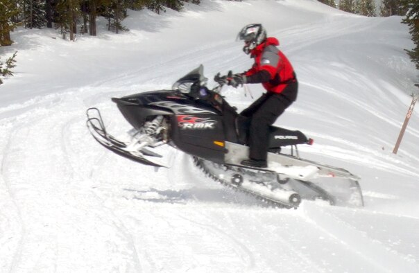 Airman 1st Class Logan Parsons, 90th Logistics Readiness Squadron, jumps his snowmobile across a path at Snowy Mountain Adventures outside of Laramie, Wyo., March 25. Warren outdoor recreation organized this trip and is preparing for the return of warm weather with new excursions (Photo by 2nd Lt. Lisa Meiman).
