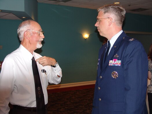 EGLIN AIR FORCE BASE, Fla. -- Retired Chief Master Sgt. Alvin Beedie talks to Col. Dean Clemons, 96th Air Base Wing commander, about volunteering.  Chief Beedie was recognized as an Angel Award winner in the Retiree category. (Photo by Lois Walsh)                        