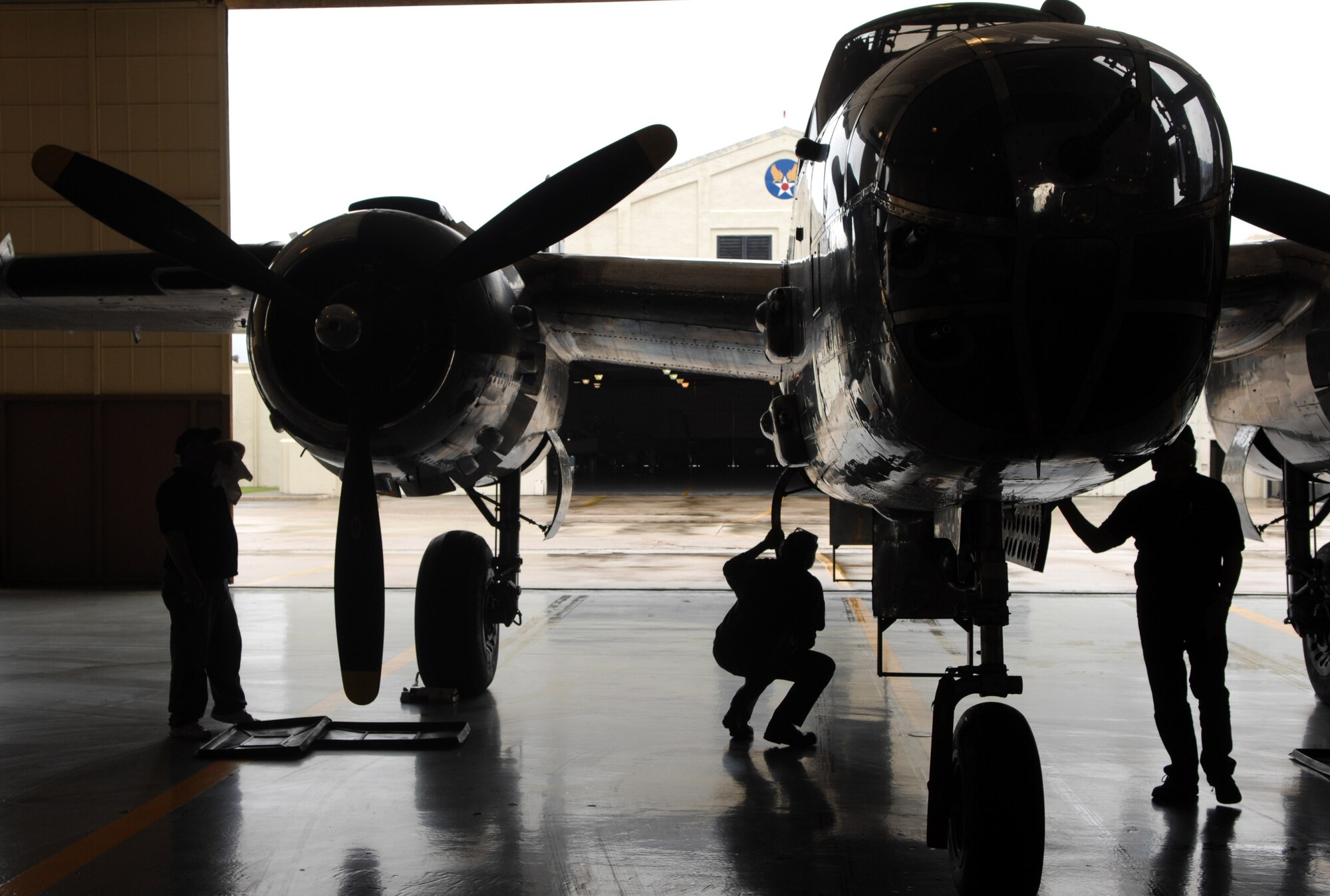 Maintenance workers wipe down a B-25 Mitchell on display April 17 at Randolph Air Force Base, Texas. The plane was the backdrop for a ceremony honoring the Doolittle Raiders and the 65th Anniversary of the Doolittle raid. (U.S. Air Force photo/Staff Sgt. Brian Ferguson) 
