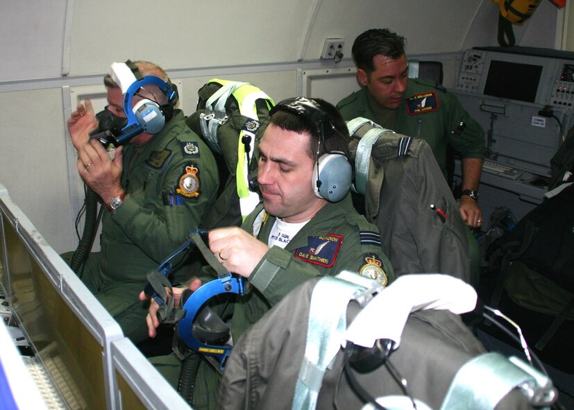 (TINKER AIR FORCE BASE, Okla) No. 8 Squadron members from Royal Air Force Waddington, United Kingdom, Master Aircrew Tony Farmer, left, and Flight Lt. Dave Smathers, right, perform their preflight oxygen mask checks while Sergeant Phil Linning conducts preflight station checks before a mission. Members of the E-3D Sentry squadron conducted a liaison visit to the 552nd Air Control Wing to open the doors for future mission training and partnership. (Photo by Staff Sgt. Stacy Fowler)