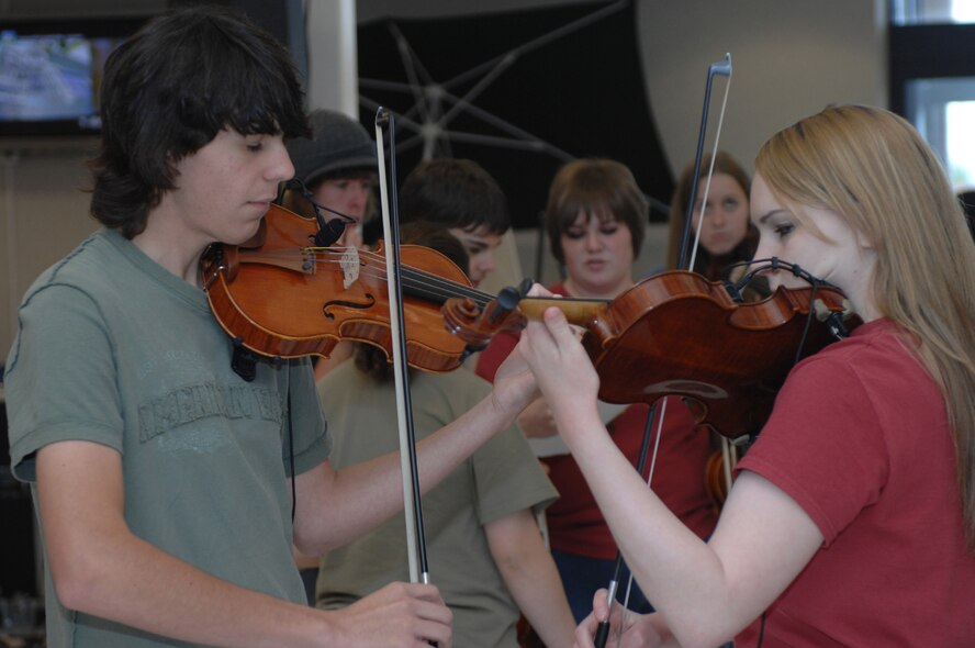Dyess celebrated the one-year anniversary of the Base Exchange April 14. Tate Pharis and Kathryn Holland, together with Abilene and Cooper High Schools orchestra members and a local band Revolutions, performed in the food court. There were door prizes, discounts, give-aways, and fun booths in the food court and throughout the store. (U.S. Air Force photo by Amn Jennifer Romig)