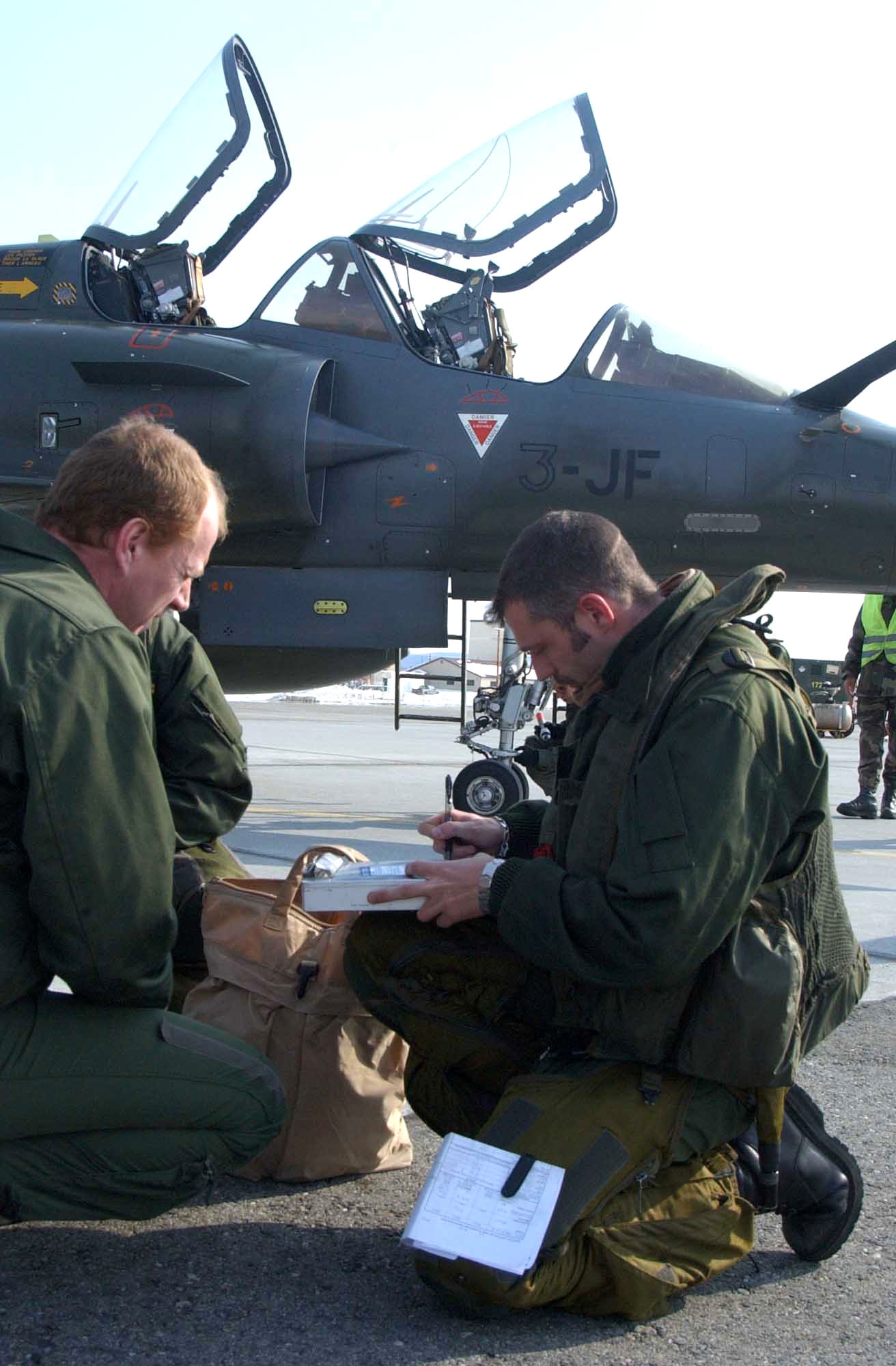 French air force pilots complete customs paperwork after landing on the flightline April 3 at Eielson Air Force Base, Alaska. Red Flag-Alaska exercise runs April 5 through April 21 and simulates air combat conditions. (U.S. Air Force photo/Senior Airman Justin Weaver)