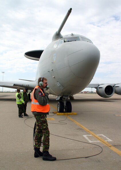 (TINKER AIR FORCE BASE, Okla) Flight Sergeant Steven Webb, one of the No. 8 Squadron maintainers deployed from Royal Air Force Waddington, United Kingdom, with the British E-3D Sentry, stays in contact with the flight deck during the pre-flight inspections before take-off. Members of the E-3D Sentry squadron conducted a liaison visit to the 552nd Air Control Wing to open the doors for future mission training and partnership.(Photo by Staff Sgt. Stacy Fowler)