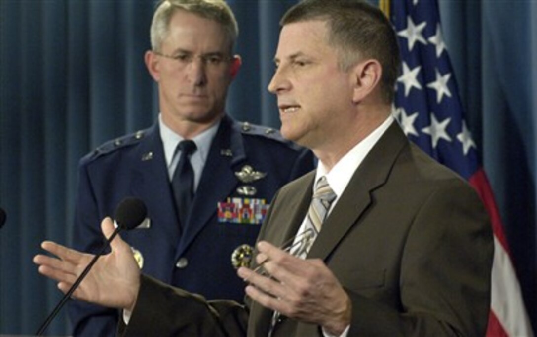 Principal Deputy Under Secretary of Defense for Personnel and Readiness Michael Dominguez (right) holds a press conference in the Pentagon on April 18, 2007, to announce a new program to recognize and compensate servicemembers who deploy or are mobilized for periods of time in excess of the established rotation policy parameters.   