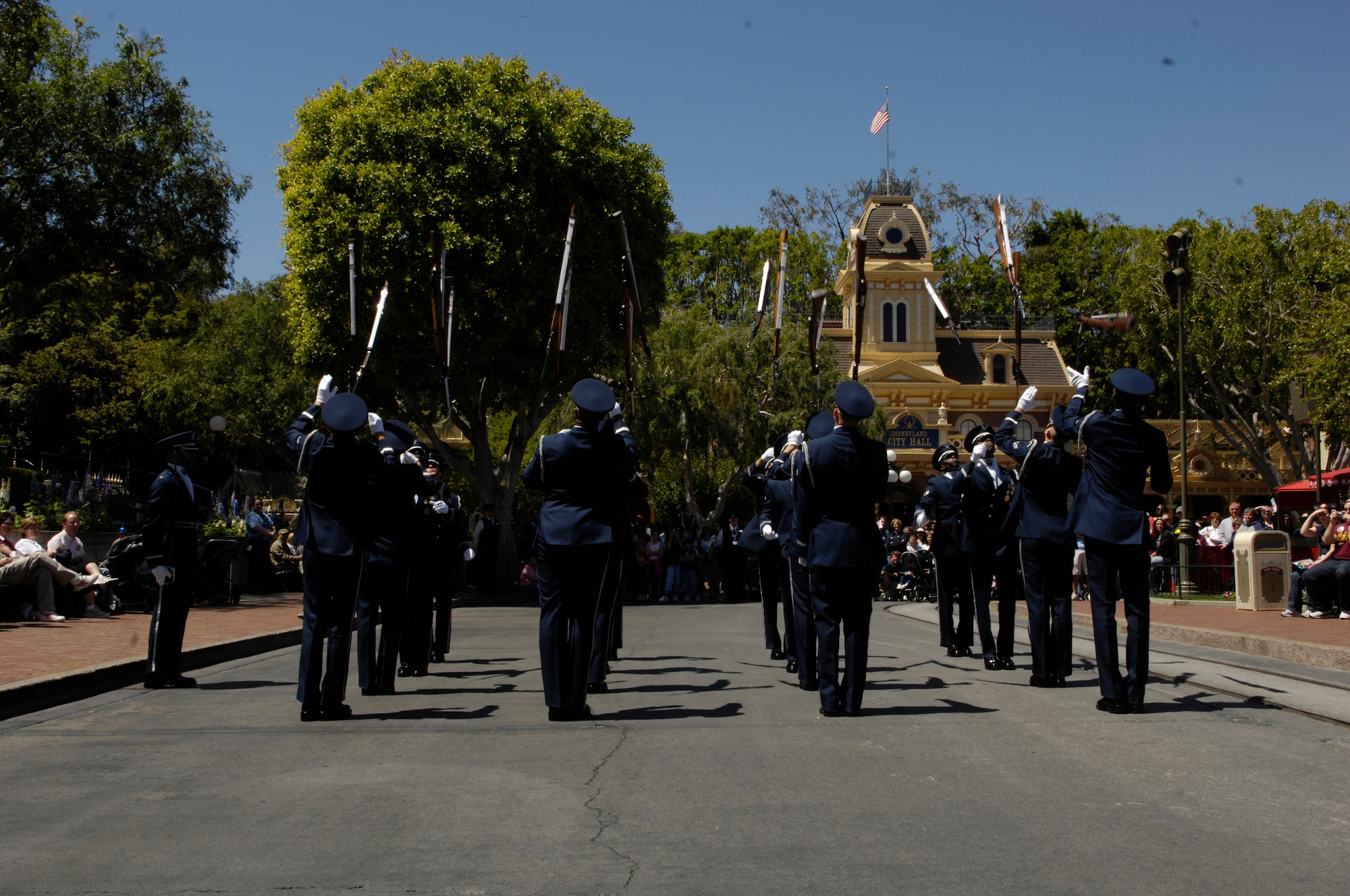 The Air Force Honor Guard Drill Team performs their newly added 'Mass Overs' maneuver where all 16 weapons are silmultaneously hurled in the air during their 16 Man drill performance at Disneyland Resort in Aneheim, Calif., 18 April 2007. The Drill Team is the traveling component of the Air Force Honor Guard and tours Air Force bases world wide showcasing the precision of today's Air Force to recruit, retain, and inspire Airmen for the Air Force mission. (U.S. Air Force photo by Senior Airman Daniel R. DeCook)(Released)