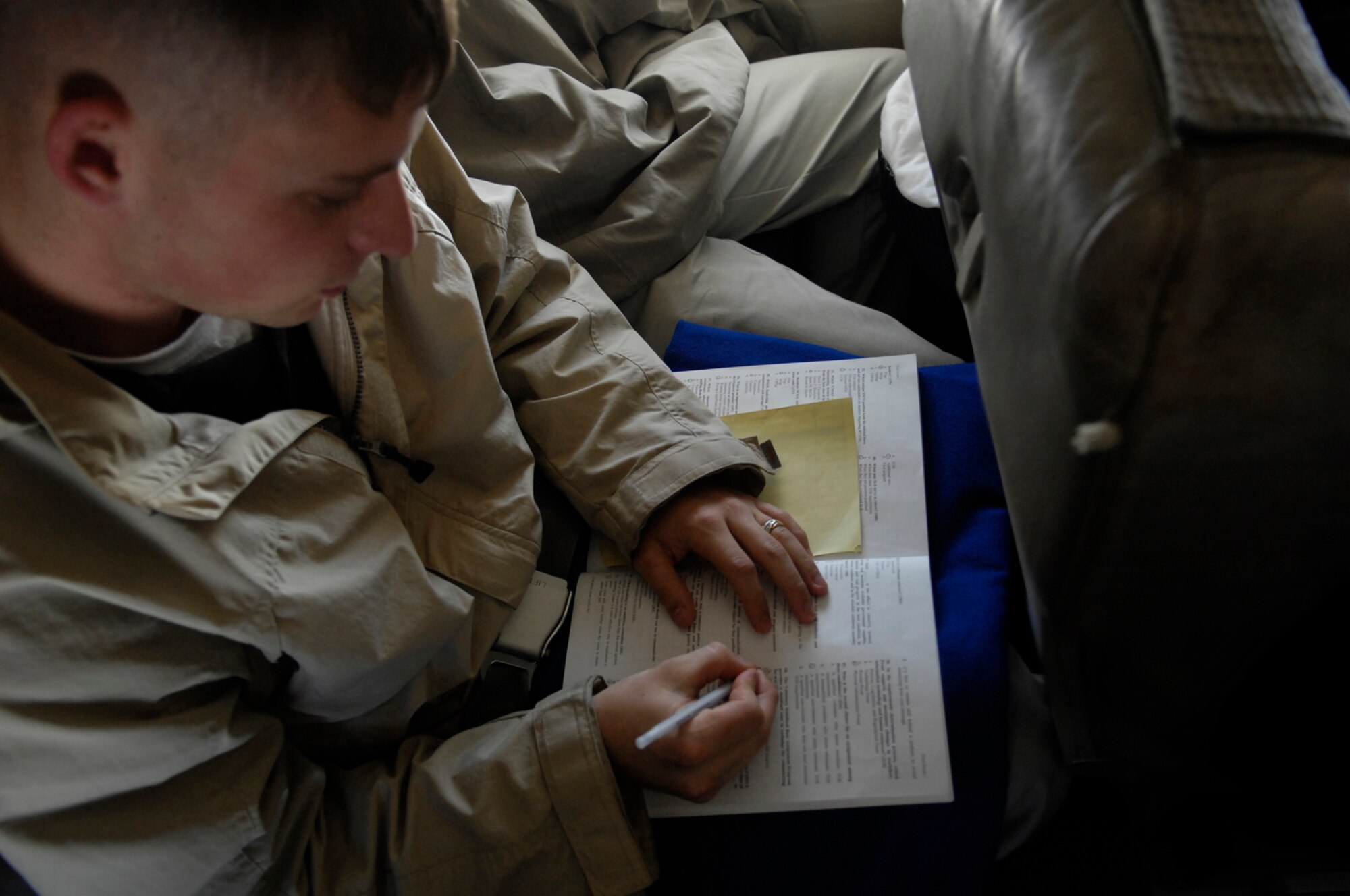 Senior Airman Raymond Testo, USAF Honor Guard Drill Team member, takes a practice test while studying for an upcoming WAPS test on a flight from Andrews AFB. Md., to Los Angeles, Calif., 15 April 2007.  The Drill Team is the traveling component of the Air Force Honor Guard and tours Air Force bases world wide showcasing the precision of today's Air Force to recruit, retain, and inspire Airmen for the Air Force mission. (U.S. Air Force photo by Senior Airman Daniel R. DeCook)(Released)