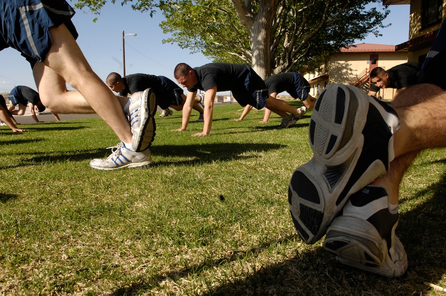 Members of the Air Force Honor Guard Drill Team conduct a group physical training session outside the High Desert Inn at Edwards AFB, Calif. on their recent tour.  Often on the road, these Airmen make use of whatever running and workout space is available to ensure they stay "fit to fight" even as they visit AF bases across the country. (U.S. Air Force photo by Senior Airman Daniel R. DeCook)(Released)